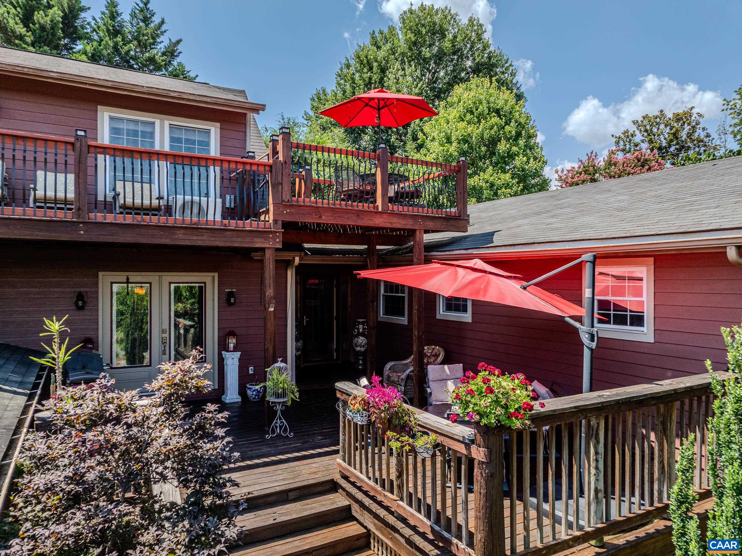 NEW PRICE and new HVAC!! Luxurious, private outdoor living spaces, upgraded kitchen and spa-like primary bathroom make this a must-see home walkable to Downtown Crozet shops and restaurants.  You'll love the solid hardwood flooring with cherry finish throughout the home. The formal living room features a grand floor-to ceiling stone fireplace as a focal point, and also includes a separate media area. The gourmet kitchen features granite counters, custom cabinetry, a striking copper double bowl sink, stainless appliances and a generous island with a built-in grill. The kitchen opens to a spacious dining room that is great for entertaining. The main level features three additional bedrooms and a full bathroom. The second floor features a secluded primary suite with two spacious walk-in closets, and ensuite bathroom boasting a freestanding soaking tub and stunning walk-in shower. Enjoy a morning cup of coffee on the private roof-top deck. The outdoor living spaces at this home stun with over 1500 sqft of private patios and decks!  With an unfinished basement, storage shed/workshop,  and two car detached garage this home is truly a gem! Current owners have rented as AirBnB on occasion but have no financial details to share.