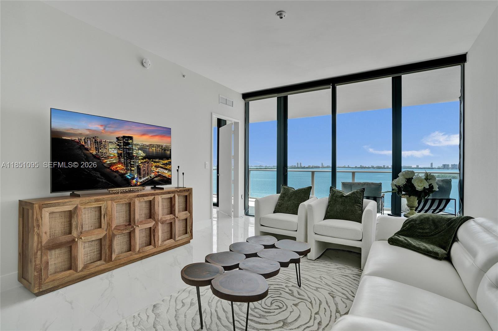 Experience refined luxury at Aria Reserve South Tower, perfectly situated in Miami’s vibrant Edgewater neighborhood. This flow-through residence offers 2 spacious bedrooms + office/den and 3  bathrooms, with floor-to-ceiling glass capturing sweeping Biscayne Bay and Atlantic Ocean views to the east; and stunning sunset views from the secondary bedroom to the west.Thoughtfully upgraded and move-in ready. Enjoy custom-finished closets throughout, including a primary suite closet with elegant backlit lighting. The bathrooms have been enhanced with new mirrors with backlighting and added shower/tub glass enclosures, elevating the look and functionality. Premium shades and blackout curtains in the bedrooms complete the comfort-forward design.Residents enjoy world-class, resort-style amenities, including a pool, state-of-the-art fitness center, spa, sports courts, kids’ areas, putting green, movie theater, and a wine lounge; all just minutes from Wynwood, the Design District, and Miami Beach.