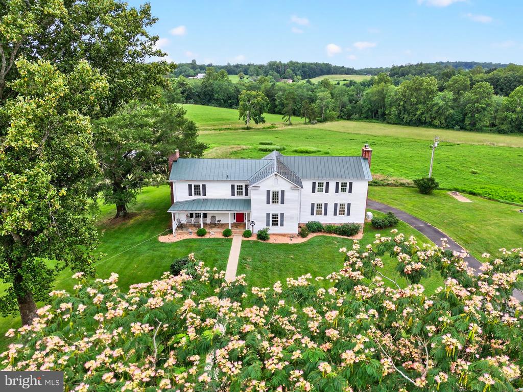 Happy Hill is an enchanting family farm that elegantly blends the past with the comforts of modern living. Set on over 57 picturesque acres the meticulously maintained 1880 Farmhouse evokes a storybook ambiance””rolling fields, tranquil pond views, and the enduring beauty of the Virginia countryside. With four spacious bedrooms””each thoughtfully designed with its own private bath””there is ample room to enjoy both privacy and comfort. The home's gourmet kitchen seamlessly opens to a sunlit family room which was added in 2013. A luxurious master suite is conveniently located on the main level with views of the pond and fields The living room and family room both have fireplaces, and the large dining room can handle all your entertaining needs. A partial conditioned but unfinished basement is beneath the family room. A charming one-bedroom guest cottage, complete with its own kitchen, living room, and full bathroom, is perfectly suited to hosting friends and family. The six-stall barn boasts a spacious tack room, washer and dryer, and bathroom facilities. A large machine workroom is also part of the barn, offering abundant space for hobbies, repairs, or creative pursuits. Situated just 20 minutes from Warrenton and only 10 minutes