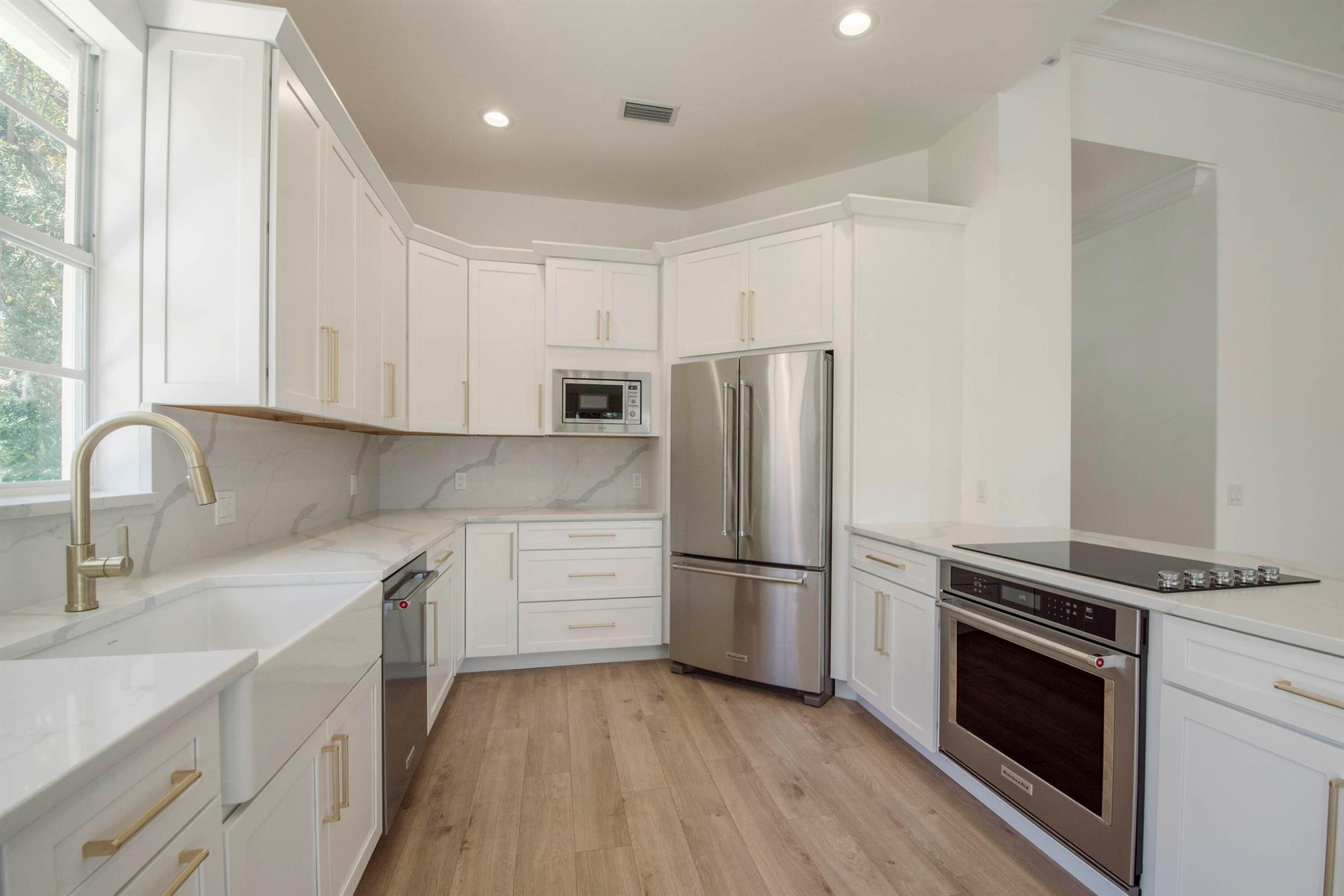 Be the first to put your personal touch on this fabulous and superior newly renovated single family home located in the premier community of Oaks East.  The gorgeous and spacious eat in kitchen features stunning white custom cabinetry throughout, brand new high end KitchenAid appliances, custom quartz countertops, farmhouse sink, new recessed lighting, a large peninsula open to the main living space perfect for entertaining, and a bonus built in bar/coffee space to enjoy while soaking up the spectacular lake views. The living and dining rooms offer tons of natural light, high ceilings, recessed lighting, durable and waterproof luxury vinyl plank transitionless flooring throughout, and wall to wall sliding glass doors that open onto your tiled screen enclosed outdoor space overlooking the pretty paver patio and wide soothing lake views and lush landscaping... the perfect place to enjoy your morning coffee or wind down after a busy day. Off the living room and through the grand tall double doorway is a generously sized primary bedroom featuring high ceilings and oversized windows to enjoy the stunning lake views, a hall lined with large walk in closets offering ample storage on the way to your spectacular spa like primary bathroom and a half bath with beautiful porcelain tiling, new vanities, wonderful free standing soaking tub, and an oversized shower featuring a frameless glass enclosure. The additional two bedrooms are located on the opposite wing of the home and are extremely sizable with abundant natural light provided by the oversized windows, with plentiful closet and storage space. Off the two guest bedrooms is a beautiful guest bath featuring stunning porcelain tile, new vanity, and new walk in shower separated by a frameless glass panel. Last but not least, don't miss the laundry room featuring brand new washer and dryer, stunning cabinetry, and a custom quartz countertop wrapping the beautiful farmhouse sink.

This newly renovated home features a brand new state of the art barrel tile roof, new gutters, a stunning impact glass front door, new impact skylights, reworked electric, poured concrete construction, brand new plumbing throughout the entire home (no polybutylene pipes), and newer ac and hot water heater. Oaks East, a highly sought after secure and 24/7 guard-gated community and the epitome of location in Palm Beach Gardens, offers magnificent mature oak tree lined and canopied streets, a beautiful heated swimming pool, hot tub, on site property manager, walker friendly sidewalks throughout, and wooded preserve and common areas with benches to take in the views, all included with VERY REASONABLE monthly HOA fees. Adjacent Oaks Park offers a walking trail, two lit tennis courts, and a picnic area while the community is also is conveniently located near to local schools, beaches, parks, endless shopping and restaurants, and is a mere 20 minute drive to the WPB airport. This home is a MUST SEE!