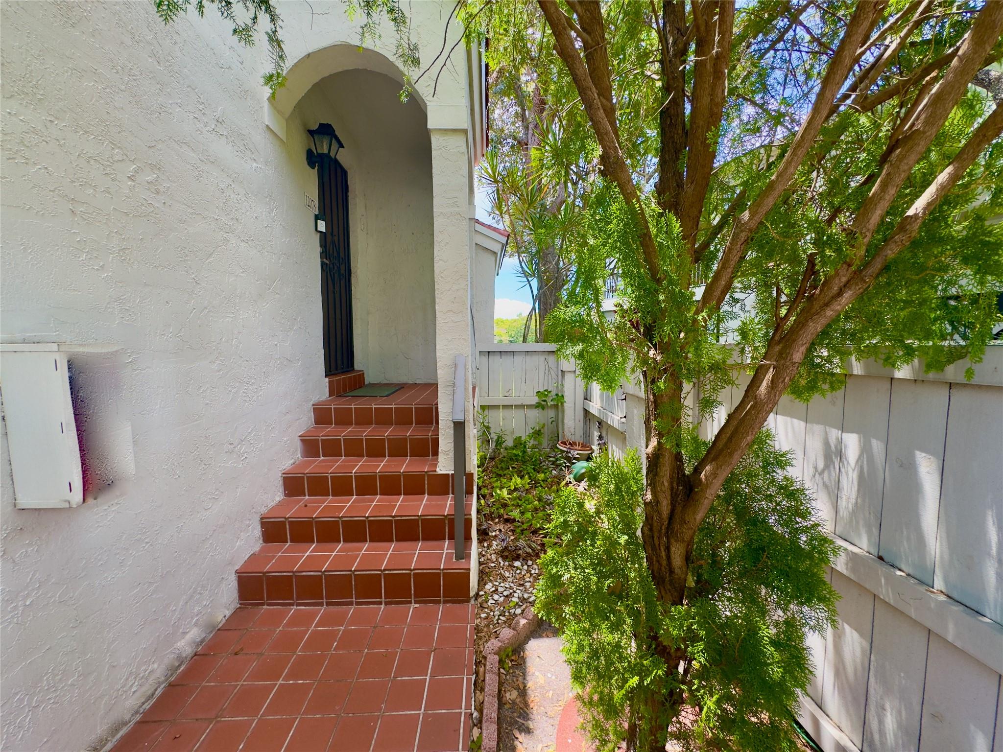 Lakeside Vibes in Pierpointe, Pembroke Pines Fl.Fall in love with this stylish 3BR/2BA corner unit in a gated community with 24/7 security. Bright split layout, sleek wood floors & plantation shutters throughout. The open kitchen pops with granite counters & stainless steel appliances. Chill or entertain on your spacious patio with serene lake views. Roof replaced in 2024, plus tankless water heater, accordion shutters & washer/dryer inside. Community getting a glow-up with new paint, PVC fencing & signage. Close to top schools, shops & highways! Updated corner unit in Pierpointe with lake views, granite kitchen, wood floors, shutters, tankless water heater, and 24/7 gated security. Community updates coming.