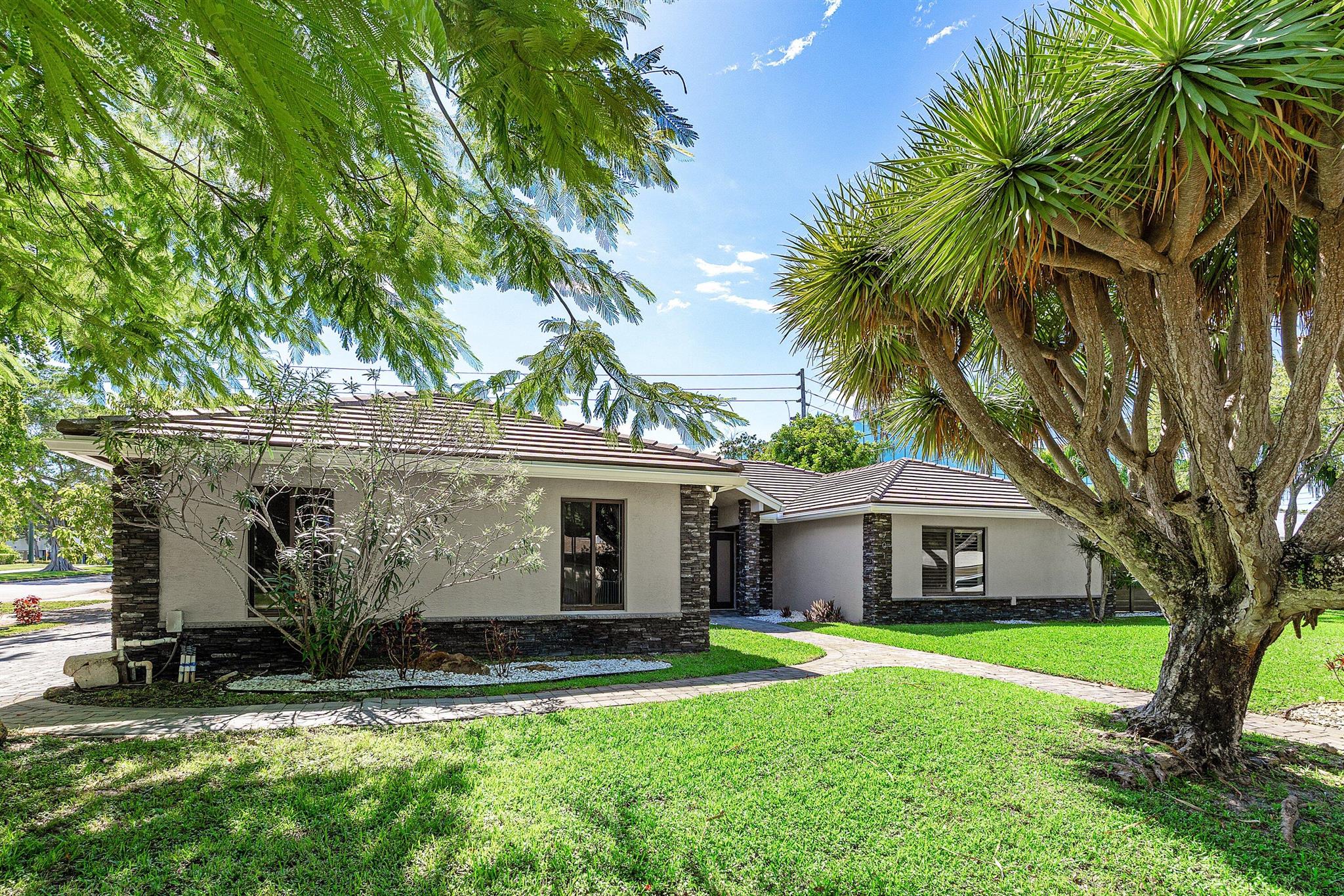 Extensively renovated home with redesigned exterior, added interior enclosure & bath, pool remodel, pavers, new fence, faux-finish garage door, tile floors, crown molding & oversized baseboards. Master suite features tray ceiling, walk-in closet & updated bath. Hurricane-impact windows/doors & garage door. Custom TV enclosure, retractable shades & garage shelving. Major upgrades include epoxy-lined water lines & new gas line for whole-home generator. Systems: 4-ton AC (2021), 1.5-ton AC (2018), water heater (2020), pool heater (2021), pool pump recently replaced.