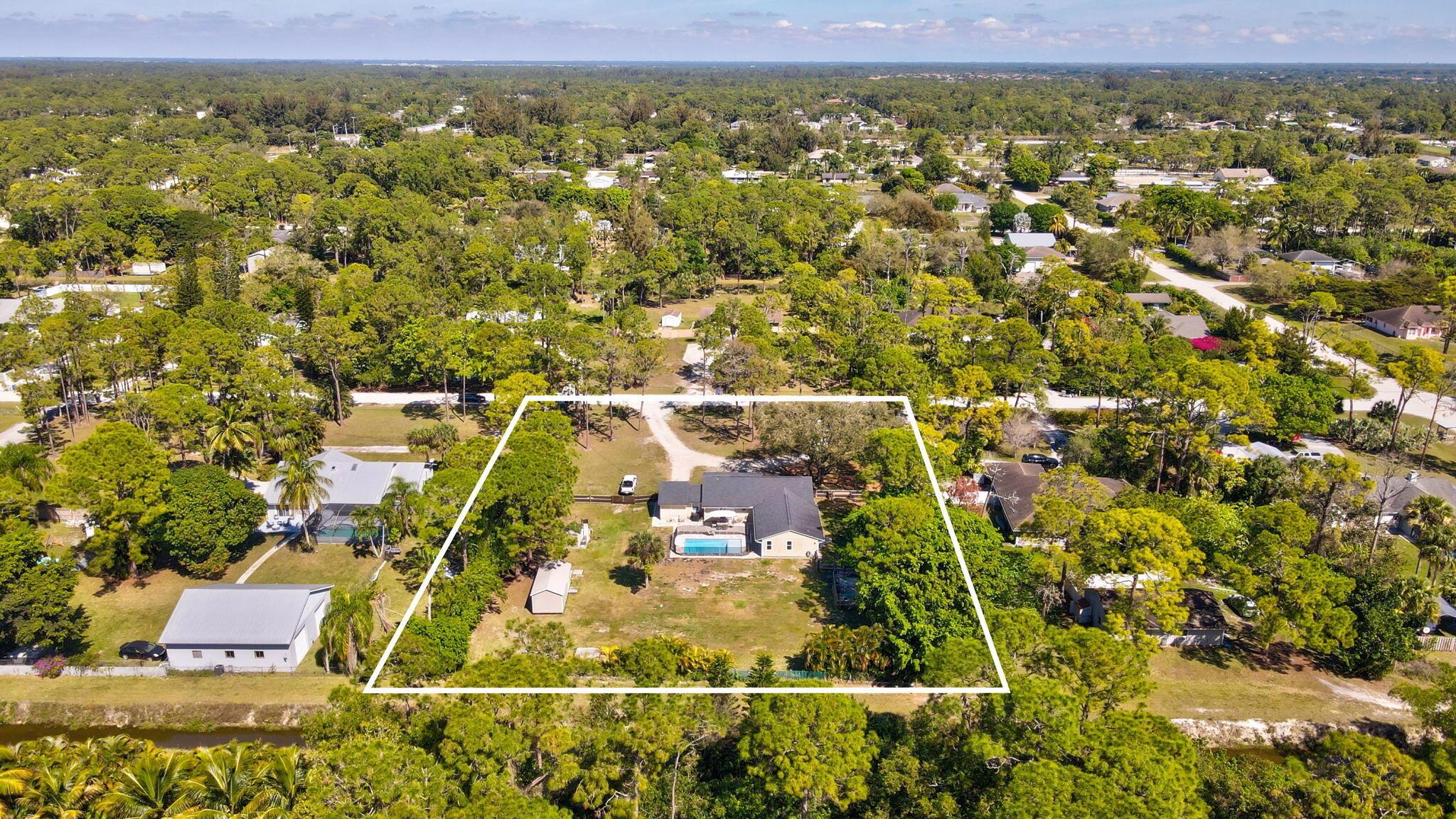 Discover the perfect blend of space, style, and serenity in this beautifully updated 5-bedroom, 3-bathroom home, set on a sprawling 1.25-acre lot. Designed for comfort and modern living, this residence boasts luxury vinyl plank flooring throughout the main house and the gorgeously updated mother-in-law suite, offering flexibility for multi-generational living or guest accommodations. The heart of the home features a sleek kitchen with granite countertops and stainless steel appliances. The bright and airy living spaces flow seamlessly to the brand-new pool and deck, creating the ultimate outdoor retreat. Peace of mind comes with all impact windows and sliders, plus a roof that's only a couple of years old. Whether you're enjoying quiet evenings by the pool or hosting