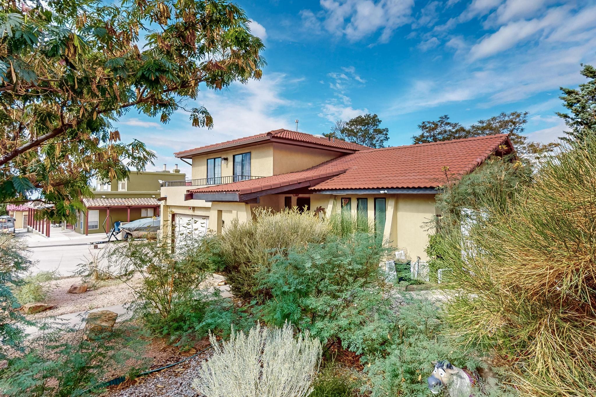 Welcome to your new home! Prime location. Large .37 Acre corner lot. This tri level home features 3 bedrooms, 3 bathrooms, office, large living spaces. Open floorplan  kitchen-dining living area and so much more. Family room with cozy fireplace. Primary suite offers full bath, dual sinks, large walk in closet and access to private balcony. Bring the party to backyard! This backyard was made to entertaining! Relax in the in-ground pool and cool off. Several relaxing patio areas around the backyard including a pergola. Room to park RV/Boat next to the home. 4 storage sheds in the bankyard. Beautiful city park across the street. Close to walking trails at the base of the Sandia Mountains. Easy interstate access. This home has something for everything one.