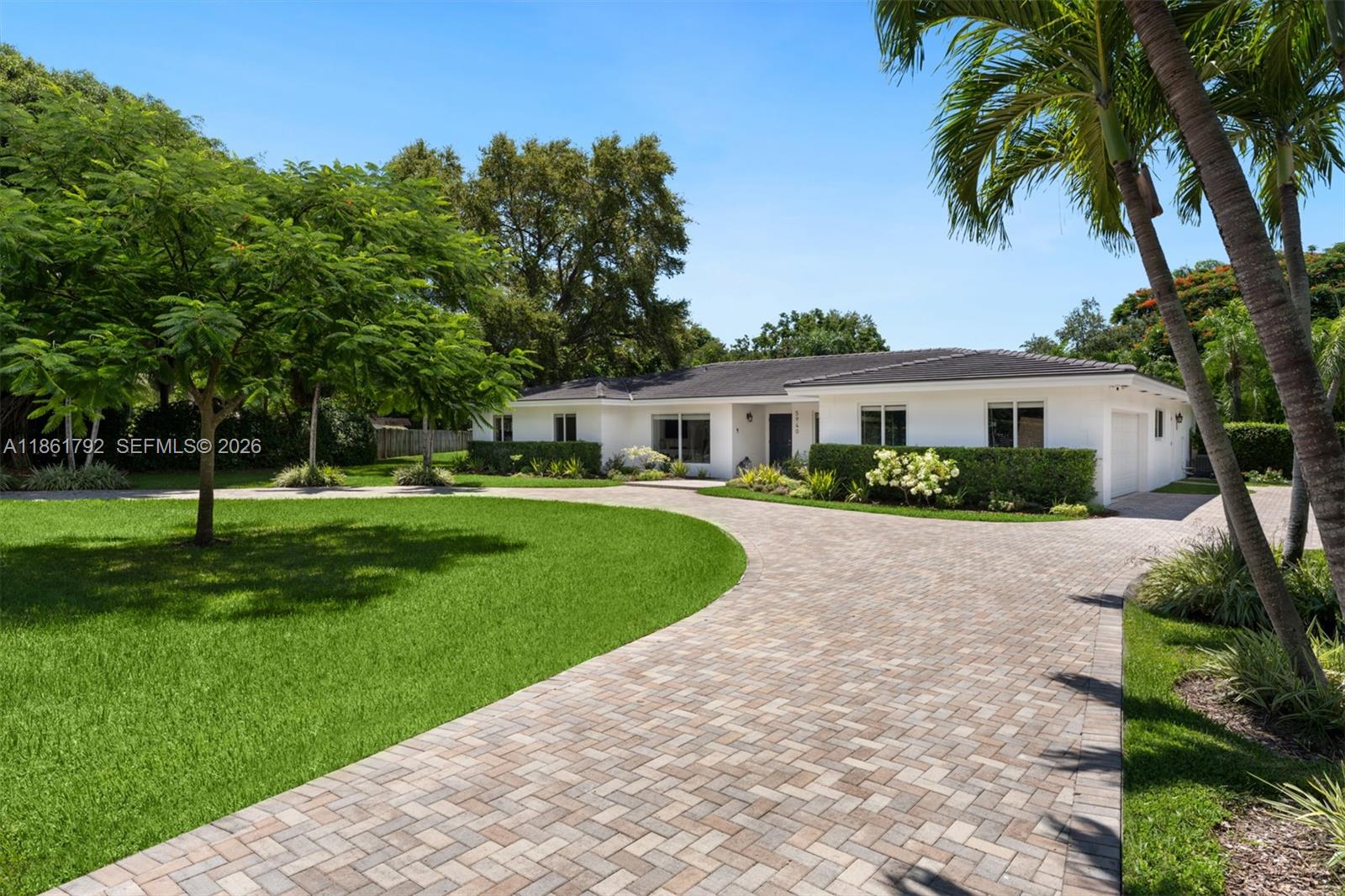 An extraordinary opportunity awaits to acquire a premier property in one of Pinecrest’s most coveted enclaves. Set on nearly an acre, this distinguished 5-bedroom, 4-bath estate features a grand circular driveway with dual gated entrances, a side-entry two-car garage, and impact windows throughout. The open-concept layout showcases a designer kitchen adorned with quartz countertops, while the expansive primary suite includes a versatile extension ideal for a private office, fitness room, or nursery. Don’t miss the chance to secure this exceptional residence and realize its boundless potential.