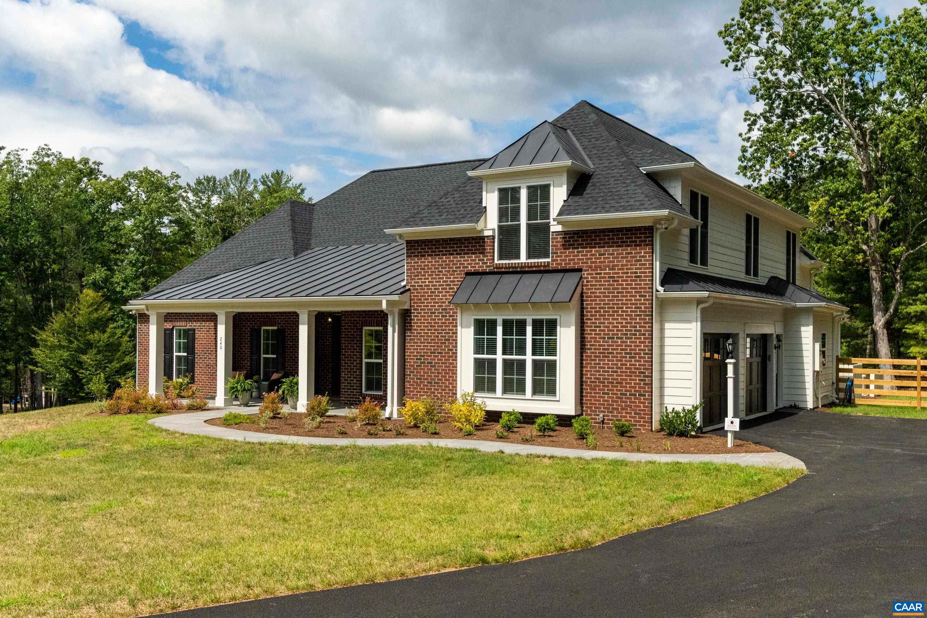 Set on a tranquil five-acre parcel just minutes from Keswick Hall and less than 15 minutes to downtown Charlottesville, this like-new home combines refined design with thoughtful upgrades. The modified floor plan enhances everyday living with a light-filled open concept that still preserves a traditional dining room and private office/den. The great room, with vaulted ceiling and seamless patio access, adjoins a gourmet kitchen outfitted with GE Monogram appliances, quartz countertops, and both a walk-in and butler’s pantry. The primary suite, privately tucked away, features a spa-like bath and enlarged walk-in closet. Two main-level guest bedrooms and a well-planned laundry complete the first floor, while an upstairs loft with full bath and bonus room offers flexibility for a fourth bedroom or retreat. Surrounded by farms and conservation land, the property enjoys a peaceful setting with seasonal mountain views and sunsets from the expansive bluestone patio. Level and mostly cleared, the land offers endless potential for gardens, outbuildings, or a pool. Elegant, practical and well-appointed, this property embodies the best of Virginia country living with all the convenience of a brand-new home.