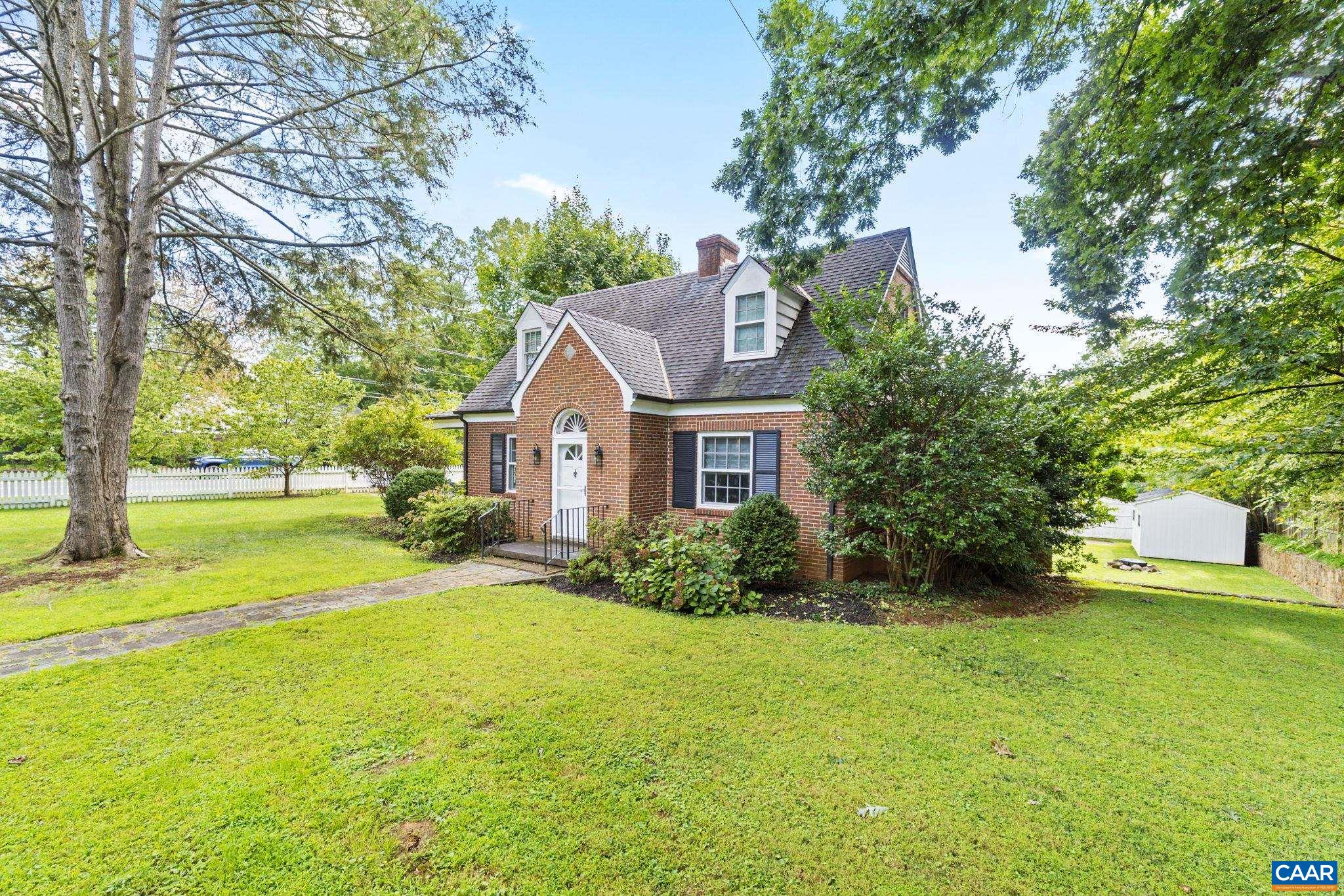 This delightful 3-bedroom, 2.5-bath cottage in the heart of Charlottesville blends storybook charm with urban convenience. The large city lot boasts a level yard with various useable spaces, two covered porches, fire pit, large shed, and a picket fence enclosure. The ideal location is walkable to the University, McIntire Park, Main Street, the Downtown Mall and The Dairy Market, as well as the Rivanna trail system and the YMCA. The well-maintained interior features hardwood floors throughout and updated kitchen and bathrooms. A finished basement offers ample space for storage, a guest area, and a laundry room.  The large lot offers plenty of room to expand, and is zoned R-C.  Enjoy hosting in the spacious dining and living rooms, or relax outdoors under mature hardwoods and fruit trees that grace the well-landscaped yard. Set on a generous corner lot, the property is newly rezoned as Residential-Commercial and offers incredible potential for future additions such as an ADU or dwelling space.  Recent additions adding great value and peace of mind include new HVAC system and water/sewer lines connecting to Public Utilities.   This home is a true gem where charm, functionality, and opportunity meet.