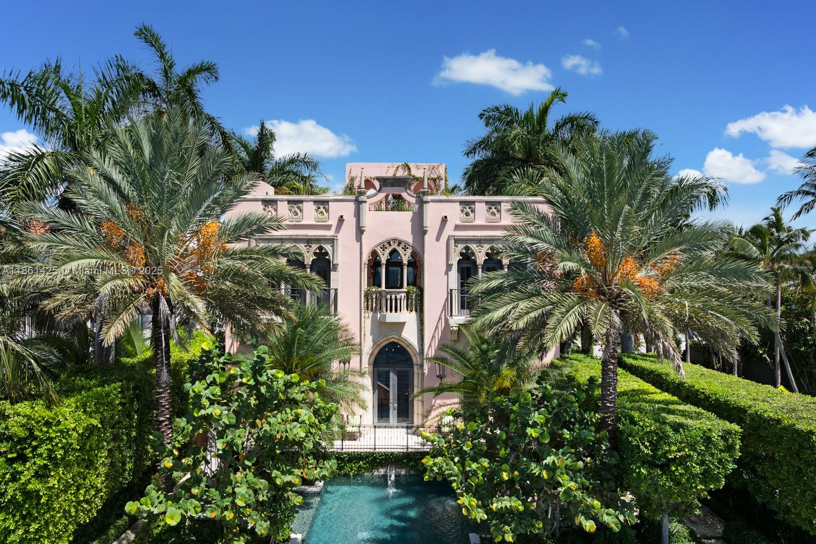 A fairytale castle in Coconut Grove, designed by Ralph Portuondo, where Gothic grandeur meets modern sophistication. The dramatic Great Hall boasts 30-ft vaulted ceilings, stone fireplaces & antique stained-glass, complemented by French cast bronze chandeliers and Jerusalem stone floors. Highlights include a La Cornue chef’s kitchen, elevator, keystone-edged infinity pool, cement dock, rooftop sundeck & terraces with water views. Landscaping by Fernando Wong, Murano chandeliers by B.F. Signoretti, and custom metalwork fencing by Belt Designs add bespoke elegance. Plus, independent living quarters with kitchen & a 3,000 sq/ft unfinished basement complete this one-of-a-kind estate.