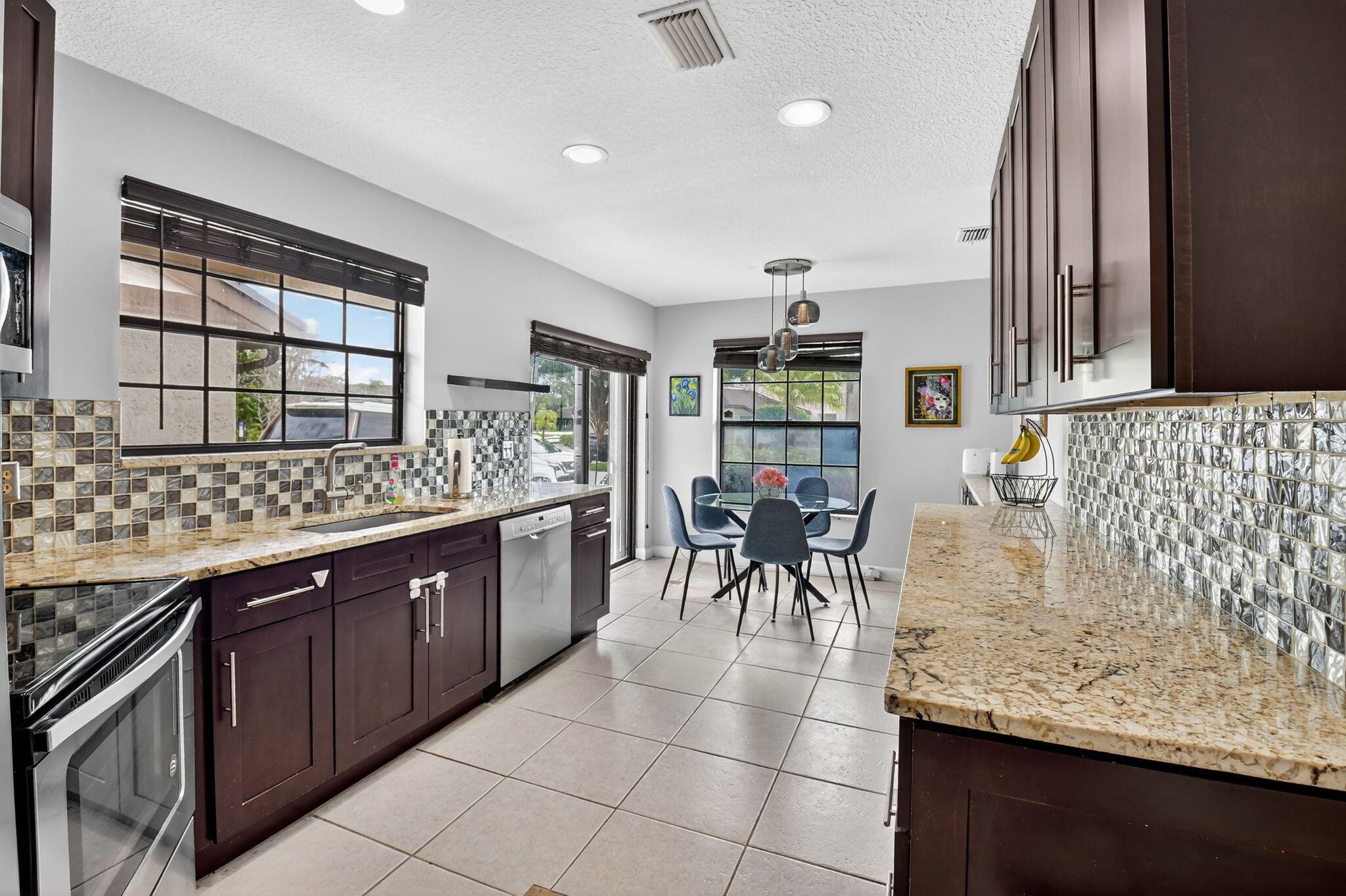 Beautifully Upgraded Townhome in Gated Boca Ridge! This spacious 3-bedroom, 2.5-bath home features a 1-car garage and a highly desirable layout with the primary bedroom on the first floor. The principal suite offers a fully renovated bathroom, while upstairs you'll find two generously sized bedrooms connected by a remodeled Jack-and-Jill bathroom. The updated kitchen boasts wood cabinetry, a stylish glass tile backsplash, stainless steel appliances (only 4 years old), and a pantry. Additional storage includes a large closet under the stairs. Recent upgrades include a 2019 A/C and a 2023 water heater. Enjoy a prime location just steps from the clubhouse, pool, and tennis courts, and within walking distance to houses of worship, restaurants, and Uptown Boca.