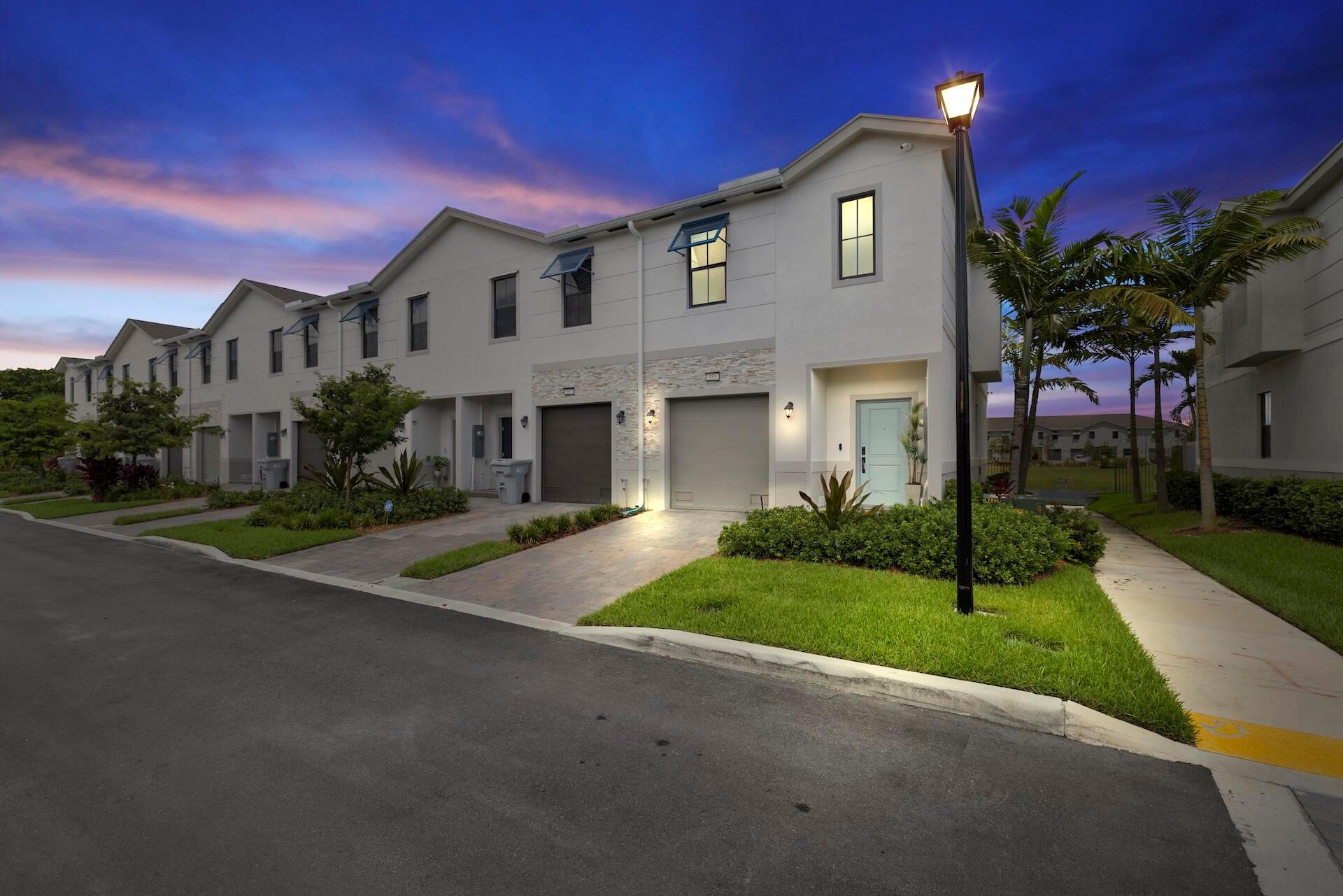 Minutes from the beach and just completed at the end of September 2024, this 1,719 sq ft 3 Bed 3 Bath corner unit is the largest floor plan offered, showcasing direct interior serene lakefront views, extensive upgrades, and a rare 4.99% assumable mortgage! The kitchen, fully renovated in August 2025, boasts extended quartz counters with a dramatic waterfall edge, matching stone backsplash, and a new June 2025 upgraded refrigerator. Bathrooms feature elegant stone finishes with a frameless glass shower in the primary. Designed as a true smart home, it offers integrated automation, advanced 360 security cameras, wood slat accent wall, zebra blinds, tankless water heater, low HOA fees, premium finishes, and a one-car garage. Low-maintenance modern lifestyle near beaches, shops, and dining!