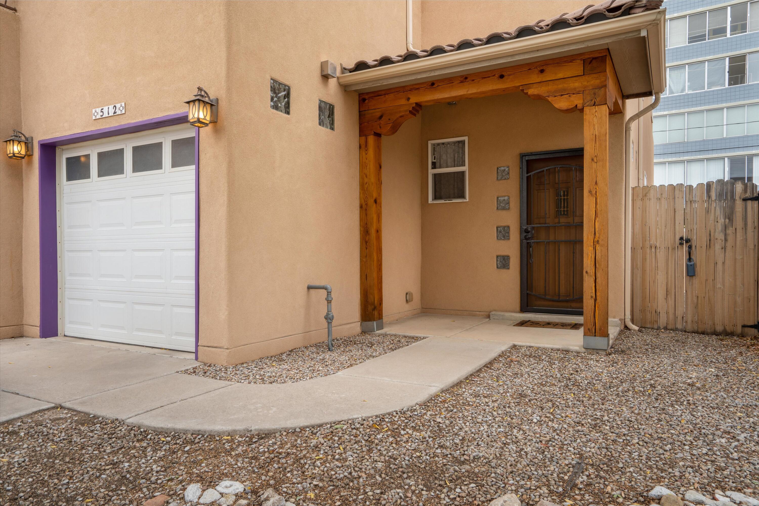 This spacious two-story townhouse, build in 2008, is just two short blocks to Rio Grande Park and Tingley Beach. Minutes to the zoo, and all of the dining, shopping and entertainment of Downtown and Old Town. Some of features of the home include updated engineered wood floors downstairs, high ceilings with clerestory windows for added natural light, refrigerated air keeping you comfortable through the warmer months, energy efficient windows, a TPO roof installed in 2019, a large primary suite upstairs with access to one of the two balconies and more. Ample off street parking with a two-car garage and enough room on the driveway to park two more cars. In the back you'll find a private backyard with enough room for table and chairs. Call your broker to see it today!