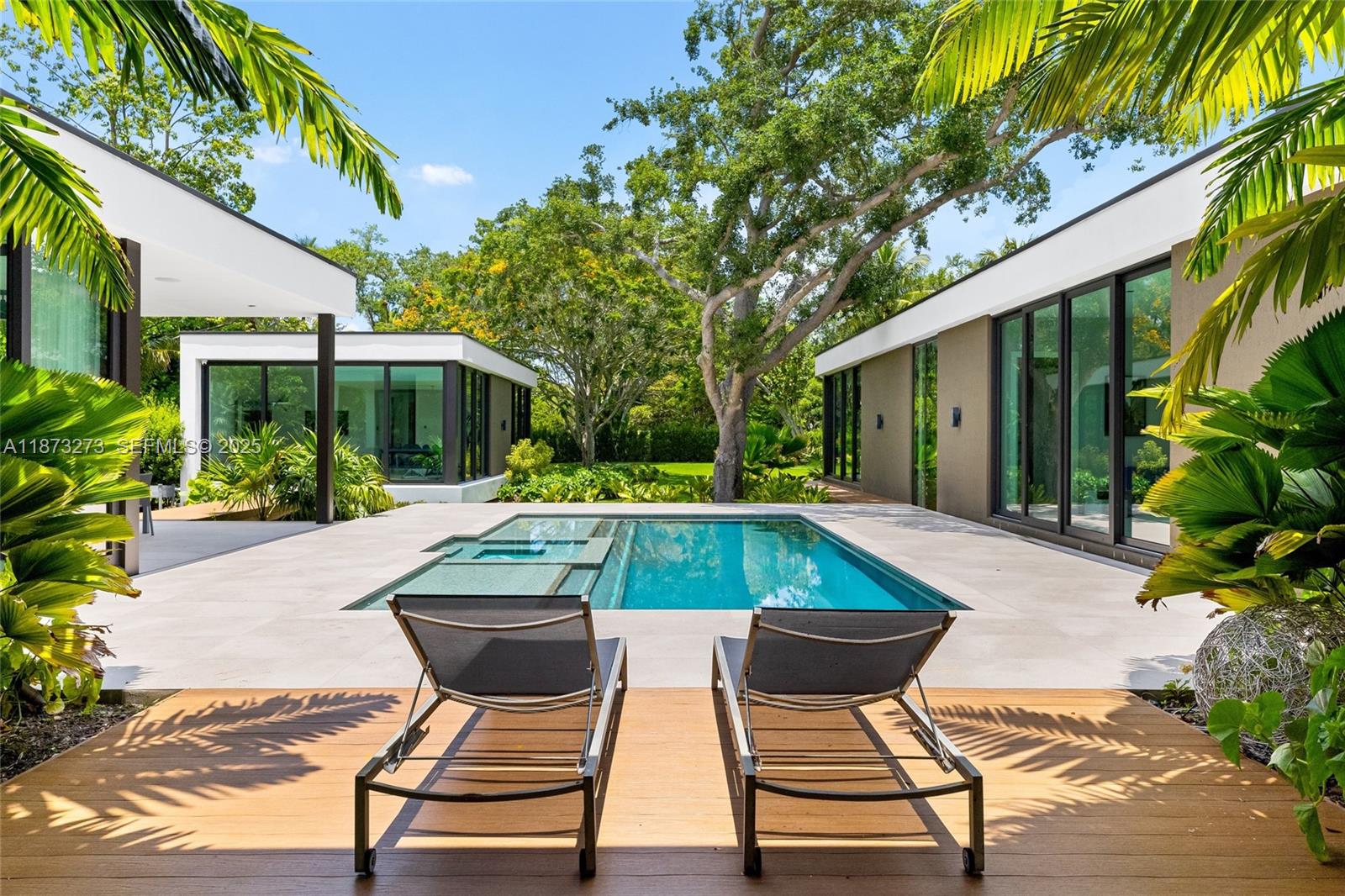 Set on a 39,639 sqft corner lot, this 2023 modern estate offers 5,847 sqft of luxury living. The main home features 6 beds, 6.5 baths, plus a detached 1 bed/1 bath suite. Designed for comfort and entertaining, enjoy a heated saltwater pool, hot tub, outdoor kitchen, putting green, and a two-car garage with EV charger. Premium finishes include Miacuccina millwork, 24x48 porcelain floors, soaring ceilings, a chef’s kitchen with Calacata Quartz, high-end appliances, & a large island. Smart features include a Control4 system, blackout shades, and more. Additional highlights: spa-style baths, walk-in pantry, laundry room, and fruit trees. Ideally located near top Pinecrest schools like Gulliver Prep, Palmetto, Beth Am, and more. Move-in ready in one of Pinecrest’s most desirable neighborhoods!