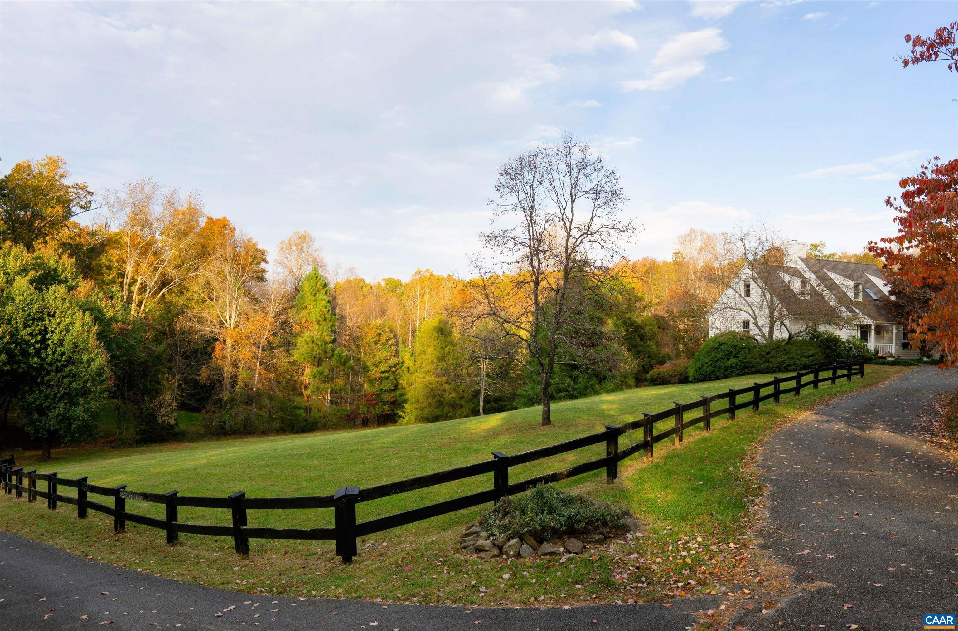 Rare opportunity to own a 'little slice of heaven' in desirable Free Union. One of a kind, architect designed. First time on the market since built; one owner. Main floor owner's suite with walk-in closet, updated en suite bath, sliding doors walkout to back deck with view of property; the perfect spot for morning coffee. Updated kitchen, wood burning fireplace in the great room, oak hardwood floors, custom built-ins throughout, and plentiful natural light with three more pairs of sliding glass doors. Charming second floor has two more bedrooms, plus a bonus room with built-ins and spacious full bath, all with oak or bamboo flooring. Fully finished light-filled basement boasting two add’l bedrooms and updated full bath and large laundry w sink, plus three more pairs of sliding glass doors opening onto brick paver patio, as well as renovated home office / workshop with custom interior Dutch door and separate exterior French door entrance. Abundant wildlife and incredible views from the full length deck overlooking open field, woods, sledding hill and spring fed pond stocked with bass. Winter mountain views. Mature landscaping: bountiful azaleas, rhododendrons, maples and more…don’t miss this opportunity! Free Union Country School.