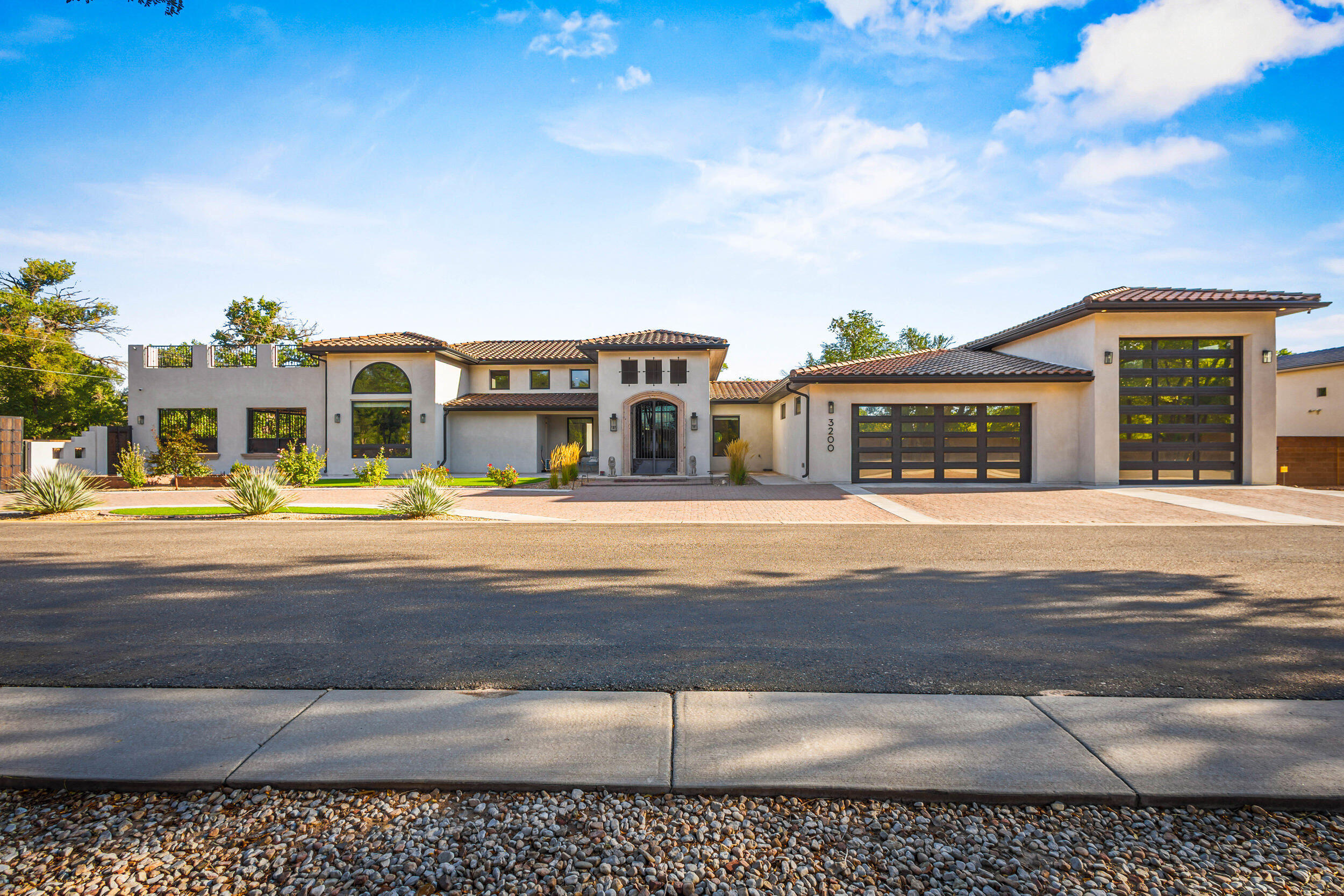 Exquisite Modern Residence in a Premier Gated Community Experience the beauty of modern Spanish design and luxury living in this exceptional Albuquerque residence. Perfectly situated with immediate access to Old Town ABQ, the Sawmill District, the Bosque trails, and just minutes from ACC Country Club, this home combines elegance, convenience, and exclusivity.The expansive open floor plan is illuminated in natural light and showcases views of the Sandia Mountains. An open kitchen and grand living spaces create the ideal setting for entertaining friends and family. Step outside to serene patios designed for peaceful evenings and relaxation.Every detail of this home reflects luxury and comfort.