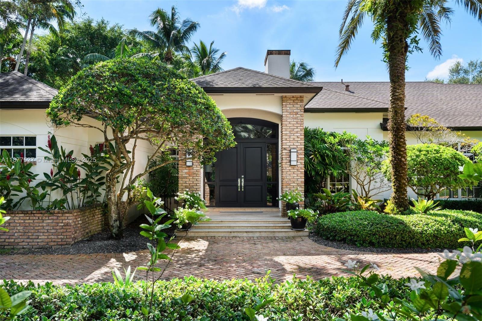 Nestled on a quiet cul-de-sac in prestigious North Pinecrest, this stunning estate offers 6 BD, 6.5 BA, and over 8,000 total SF of refined living. Set on a lushly landscaped acre with specimen palms, the home boasts soaring ceilings, Italian porcelain floors, a custom bar, wine room, home theater, and gym. The gourmet kitchen features Sub-Zero/Miele/Wolf appliances, marble counters, and custom cabinetry. The expansive main suite includes a sitting area, office, dual walk-in closets, and spa-like bath. Resort-style outdoor living offers a saltwater pool with waterfall spa, covered terrace, summer kitchen, tiki hut, and basketball court. Additional features: 3-car garage, full-home generator, smart systems, and full security. A rare Pinecrest offering, moments from top rated schools, blending luxury, comfort, and privacy.