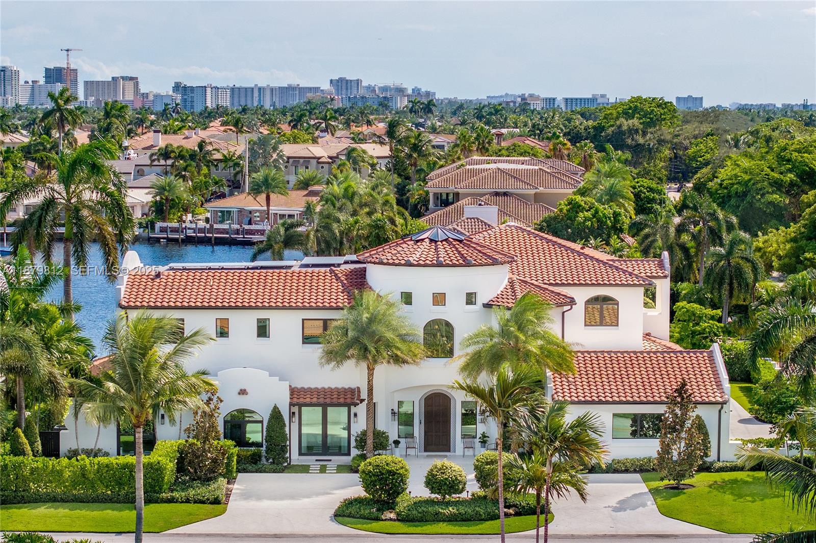 An extraordinary waterfront estate offering 8,433 sq ft with 8 bedrooms, 9 baths and Spanish Mediterranean charm. Designed by Monogram Studios Lisa Mayock, this 2022 residence blends modern construction with Old-World elegance, inclusive of stucco walls, barrel-tile roof, and arches. The oversized corner lot residence opens with a skylight centerpiece followed by a chef’s kitchen with Gaggenau & Sub-Zero appliances, two laundry rooms, dual-control wine cooler, media room, butlers pantry, pilates/gym, and office. For seamless indoor-outdoor living: loggias, courtyards, summer kitchen with retractable screens, cabana bath, 4-car garage, and 50 ft of water frontage. With no fixed bridges, an extra wide canal and only minutes to the ocean this is a true statement home in Lighthouse Point.