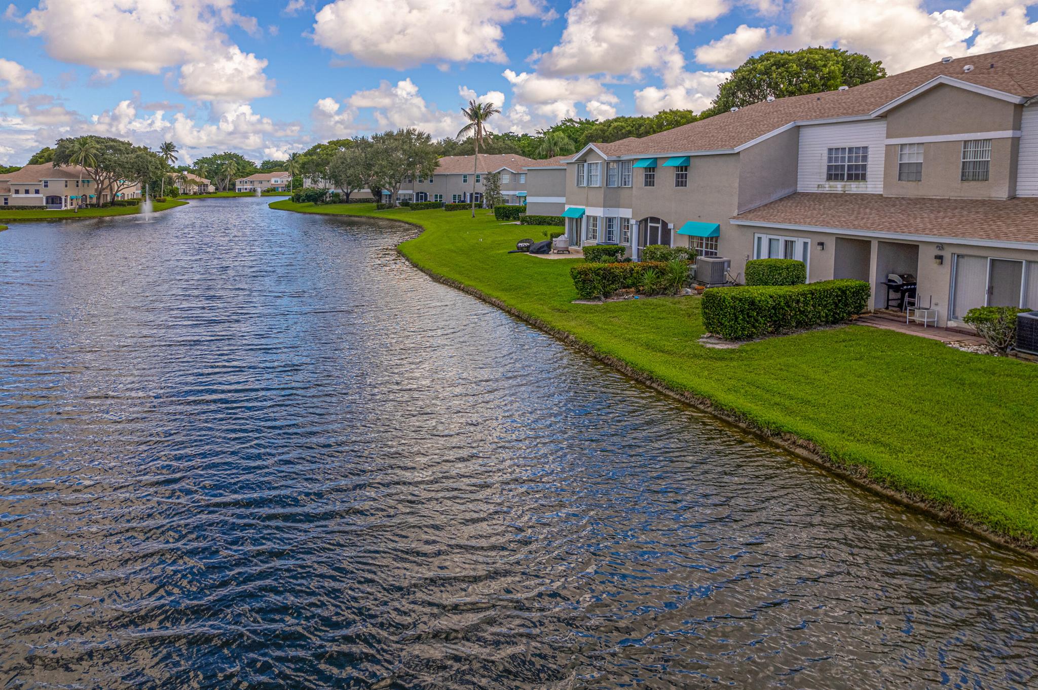 ONE OF THE LARGEST TOWNHOMES IN BOCA. ENDLESS LAKEVIEWS!! A beautifully maintained 2,268 sq. ft. townhome featuring the most favored layout in the Boca Gardens community.Step inside to find a spacious and inviting design with high ceilings and abundant natural light. This residence offers 3 bedrooms plus a bonus room (ideal as a 4th bedroom or office), 2.5 bathrooms, and an attached garage for convenience.The kitchen has been completely remodeled with modern upgrades, including soft-close cabinetry, convenient pullouts, and lazy Susans, along with stainless steel appliances and generous counter space. The primary suite features vaulted ceilings, a walk-in closet, and a beautifully remodeled bathroom with dual sinks and a frameless glass shower 
 Two additional bedrooms share a full bath, ideal for family or guests.
Design elements include tile flooring downstairs, engineered wood upstairs, and soaring vaulted ceilings throughout the second floor. A full laundry room with washer and dryer access upstairs adds everyday convenience.
Enjoy outdoor living on the large screened-in patio with peaceful lake views. The water is stocked with fish, offering the perfect spot to unwind or cast a line for the fisherman in your life.
Living in Boca Gardens means resort-style amenities right at your fingertips: 3 community pools, tennis and pickleball courts, a clubhouse, playgrounds, and walking paths. All this with low HOA fees that include cable, internet, roof maintenance, and exterior care.
Conveniently located near A-rated schools, shopping, restaurants, and major highways, this home offers both comfort and lifestyle.
Don't miss this opportunity to own one of the most desirable models in Boca Raton's Boca Gardens!