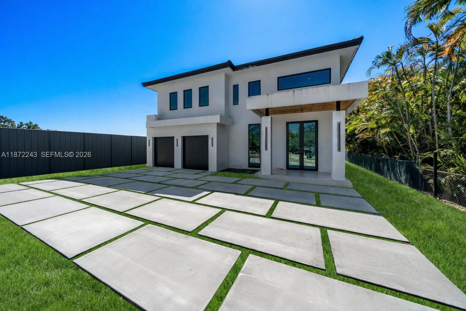 Be the first to own this brand-new 5-bed, 5-bath modern masterpiece, set for completion in February 2026. Situated on a 20,468 sq ft lot, this luxury home features porcelain tile floors, a sleek tube elevator, hurricane-resistant construction, and an EV-ready 2-car garage. The chef’s kitchen boasts Thermador appliances, quartz counters, and custom cabinetry. Upstairs offers a flexible loft and a serene primary suite with a private balcony, dual walk-in closets, and a spa-style bath. The deep backyard oasis includes a pool, summer kitchen, and ample space to relax or entertain.