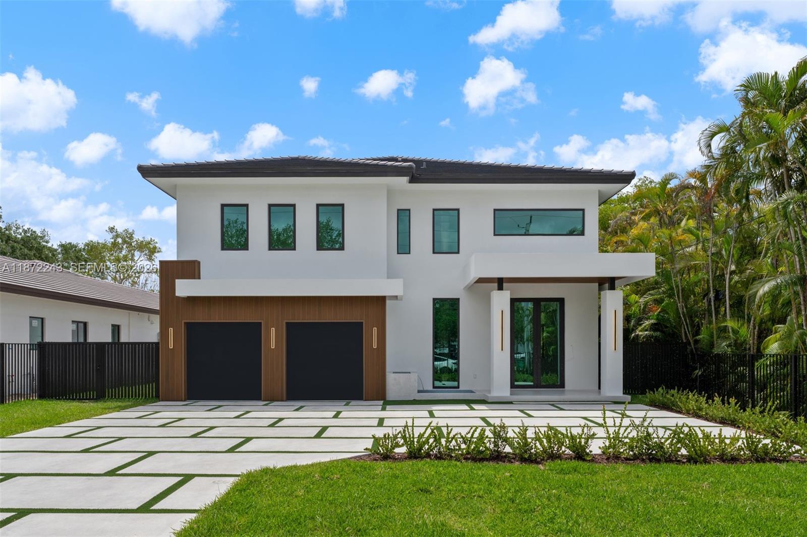 Be the first to own this brand-new estate, a 5-bed, 5-bath modern masterpiece set on a 20,468 sq ft lot. Thoughtfully designed with exceptional finishes, the home features elegant porcelain tile floors, a sleek tube elevator, hurricane-resistant construction, and an EV-ready 2-car garage. The gourmet chef’s kitchen showcases Thermador appliances, quartz countertops, and custom cabinetry, creating a refined space for everyday living and entertaining. Upstairs, a versatile loft complements a serene primary suite with a private balcony, dual walk-in closets, and a spa-inspired bath. The deep backyard retreat offers a pool, summer kitchen, and expansive space to relax or host guests in style.