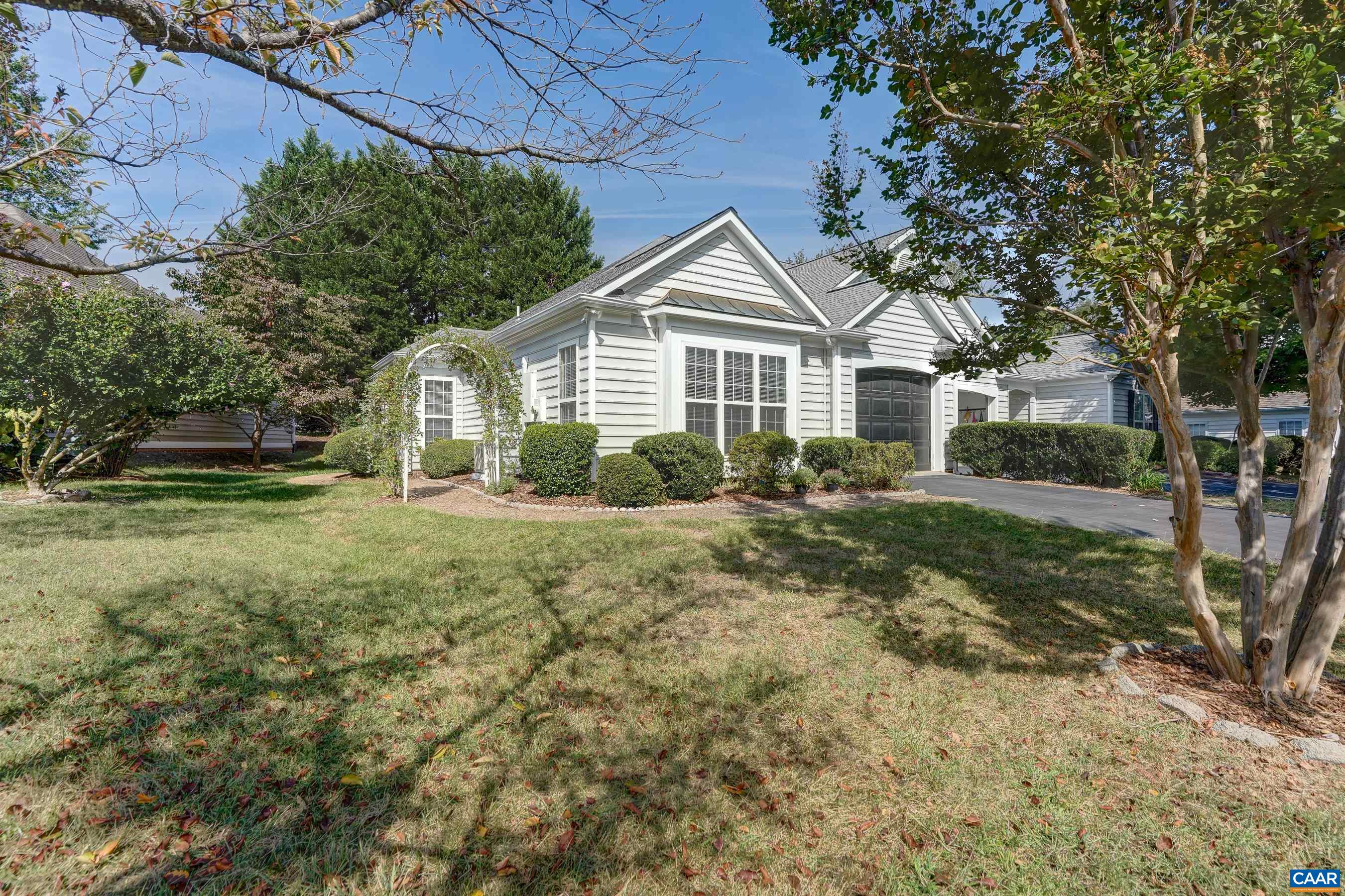 Peaceful living in the heart of Charlottesville! Tucked away in this centrally located neighborhood, this one level villa home provides a quiet sanctuary while being minutes from 5th St. Station, Wegmans, UVA and downtown. The open floor plan flows seamlessly from the large renovated eat-in kitchen with granite countertops, updated white cabinets, and new dishwasher and microwave. Formal dining area and lovely living room with soaring vaulted ceiling, and sliding doors leading out to the private back patio. The primary bedroom features two large closets and an updated ensuite bathroom with new vanity, commode, and showerhead. A second spacious bedroom with full bath that is great for guests and an additional room that can be used as an office, playroom or guest room round out this warm sun-filled home. This home features a new roof and one car garage too! Professionally landscaped with mature hedges and seasonal flowers. Neighborhood amenities such as walking/running trails, a playground, and pool are within walking distance.
