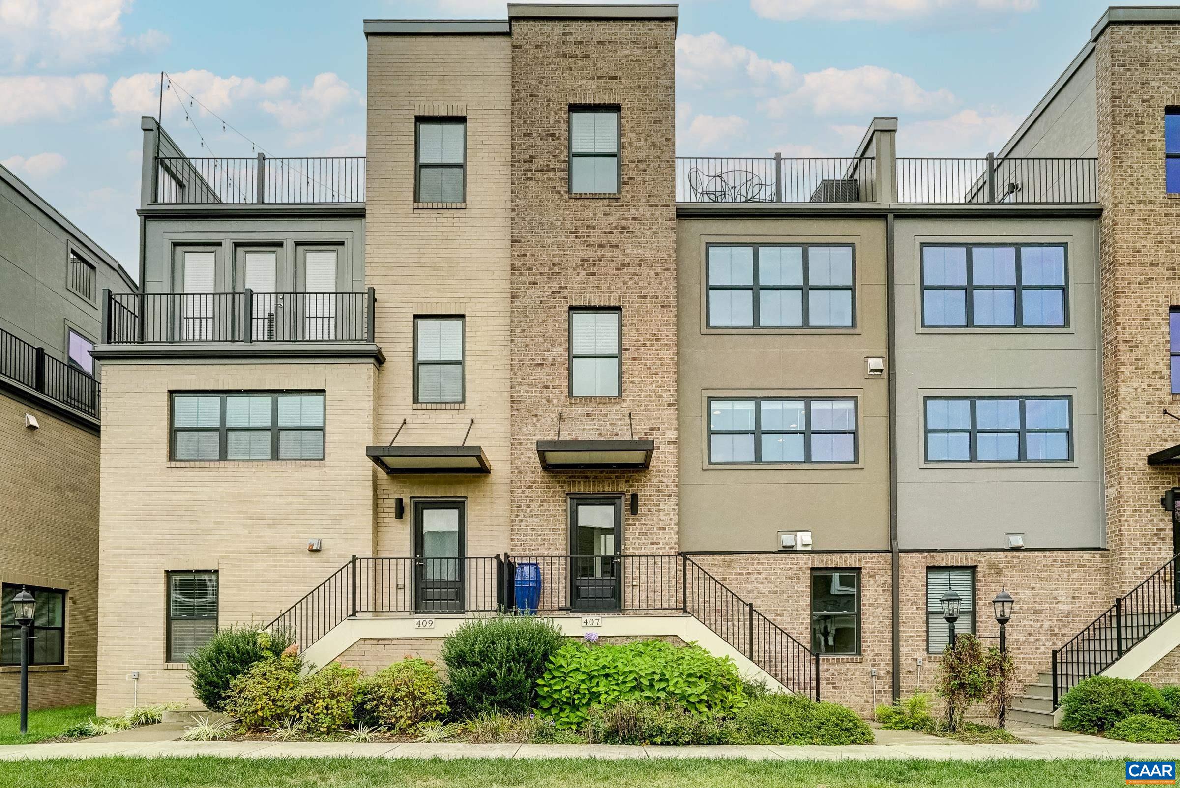 The views!!  Amazing!  Discover an extraordinary living experience in Old Trail, where this stunning four-story, townhome on green space combines modern design with breathtaking mountain vistas walkable to the Town Center. Step inside to an inviting, light-filled interior featuring natural hardwood floors, and custom window treatments.  The heart of the home is an open-concept living area with a gourmet kitchen that boasts espresso stained cabinetry, luxurious granite countertops and upgraded stainless steel appliances that opens to a great room with electric fireplace and large dining area. The bedroom level showcases a generously sized owner's suite with walk-in closet and a spa-inspired bathroom, featuring a sleek frameless glass shower. A second large bedroom with ensuite bathroom is great for guests!  The ground floor offers versatility with a third bedroom/home gym with full bathroom. Perhaps the true gem of this property is the spectacular loft leading to the rooftop terrace—an urban oasis with panoramic mountain views that will become your favorite retreat. New HVAC system in 2025 comes with warranty! Practicality meets luxury with a two-car garage and a convenient rear deck for outdoor dining and grilling Don't miss out!