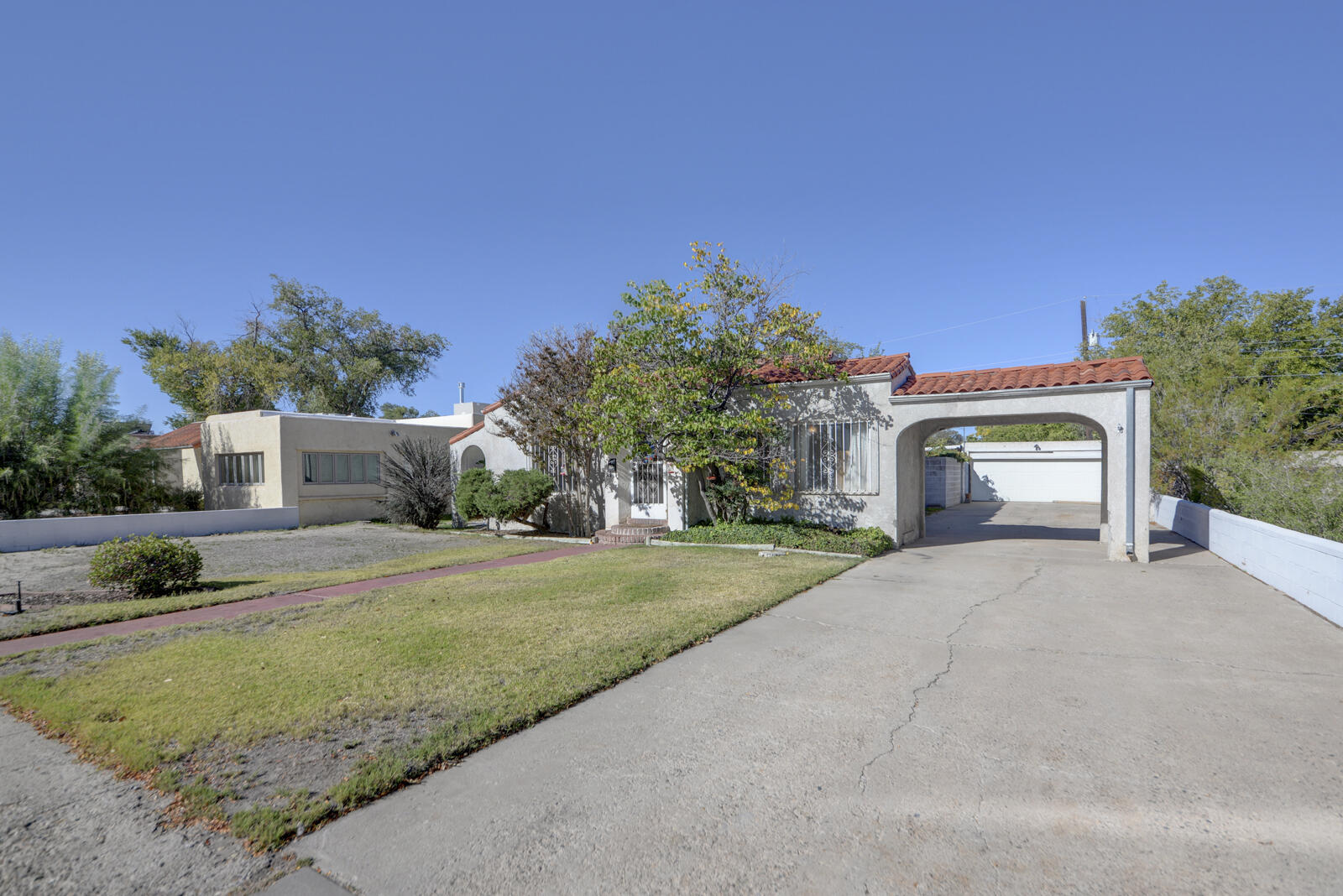 Vintage charm in the heart of the beautiful Albuquerque Country Club area! This 2 bedroom home with a dedicated office offers timeless character and thoughtful spaces throughout. Beautiful wood floors and separate dining room perfect for entertaining! Detached 2 car garage plus a 275 sf workshop. Near the Albuquerque Little Theater and near Old Town too!                                                                                 Roof replaced 2022, heating and cooling replaced in 2021, water heater in 2023 and stackable W/D in 2022.