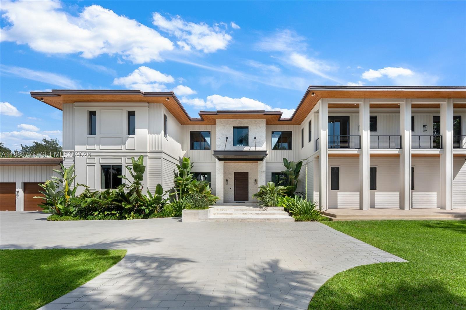A timeless blend of elegance and comfort, this exceptional two-story residence offers 7 bedrooms, 7 full baths, and 1 half bath, thoughtfully curated for refined living. Soaring volume ceilings, impact glass, and bespoke built-ins elevate each space with understated sophistication. The gourmet kitchen showcases custom cabinetry, Wolf appliances, Sub-Zero refrigeration, and a Sub-Zero wine cooler, seamlessly flowing into the wet bar and living areas. A glass-enclosed porch with a summer kitchen featuring a pizza oven invites effortless indoor-outdoor entertaining. Additional highlights include a club room, media room, and the potential for a backyard pickleball court with available renderings.