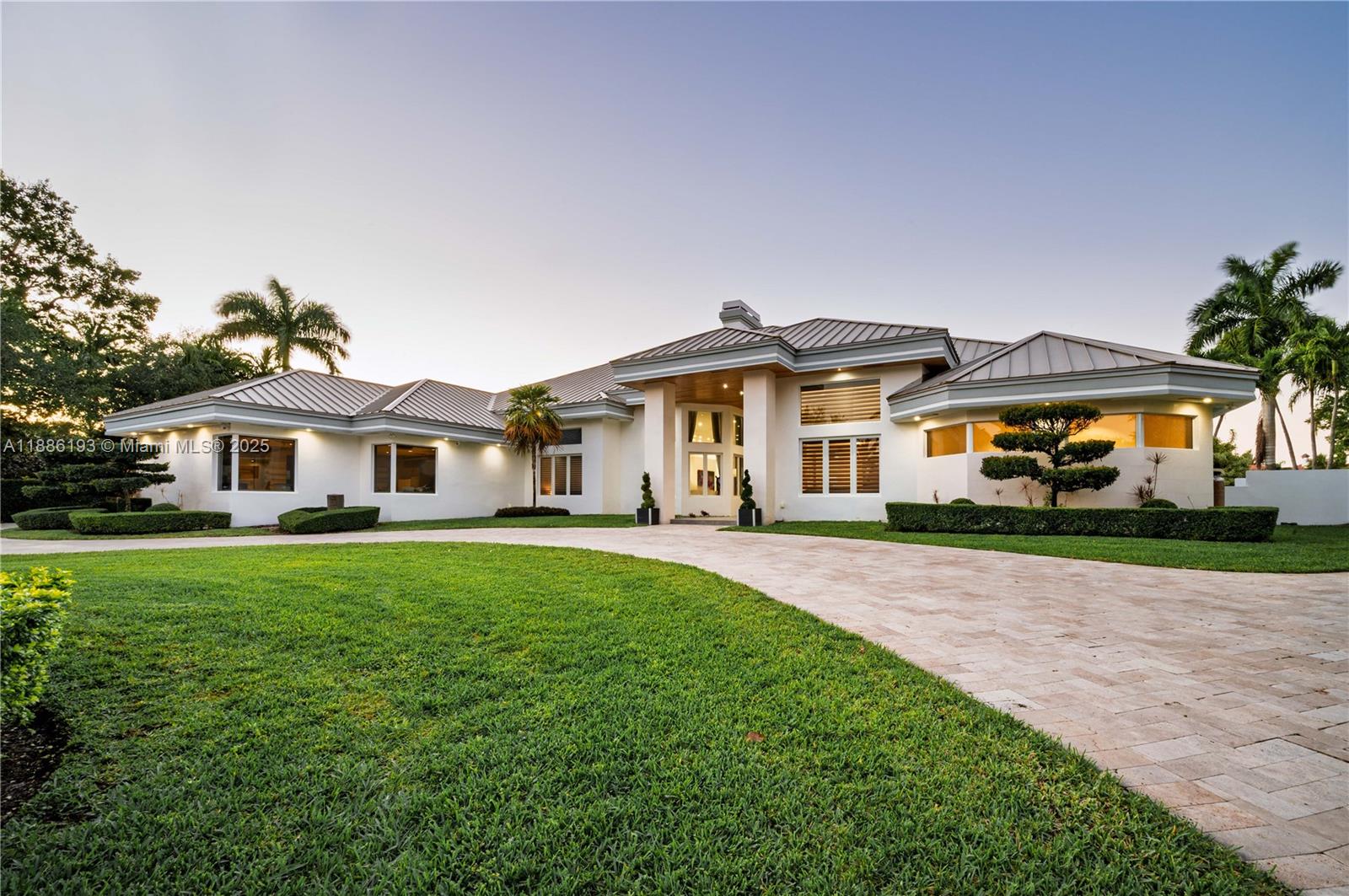 A masterpiece in Weston’s prestigious Windmill Ranch Estates. This 1.3-acre private estate features 5 spacious bedrooms, each with its own ensuite bath, plus a stylish guest bath. Fully renovated in 2018, the home showcases Italian marble floors throughout the main living areas, wood flooring in all bedrooms, and a durable metal roof that brings both elegance and peace of mind. A custom home theater, private DEN/OFFICE, soaring ceilings, and exquisite designer finishes elevate every corner of this residence. The chef’s kitchen shines with top-tier appliances, ceramic counters, and an open flow ideal for entertaining. Step outside to breathtaking lake views, a resort-style pool, marble patio, lush gardens, and total privacy. Additional highlights include impact windows and doors and an epoxy-floored 3-car garage. Zoned for A+ schools. This move-in ready estate blends elegance, lifestyle, and sophistication in one of Weston’s most exclusive communities. Experience resort-style living every day — this is the one you've been waiting for.