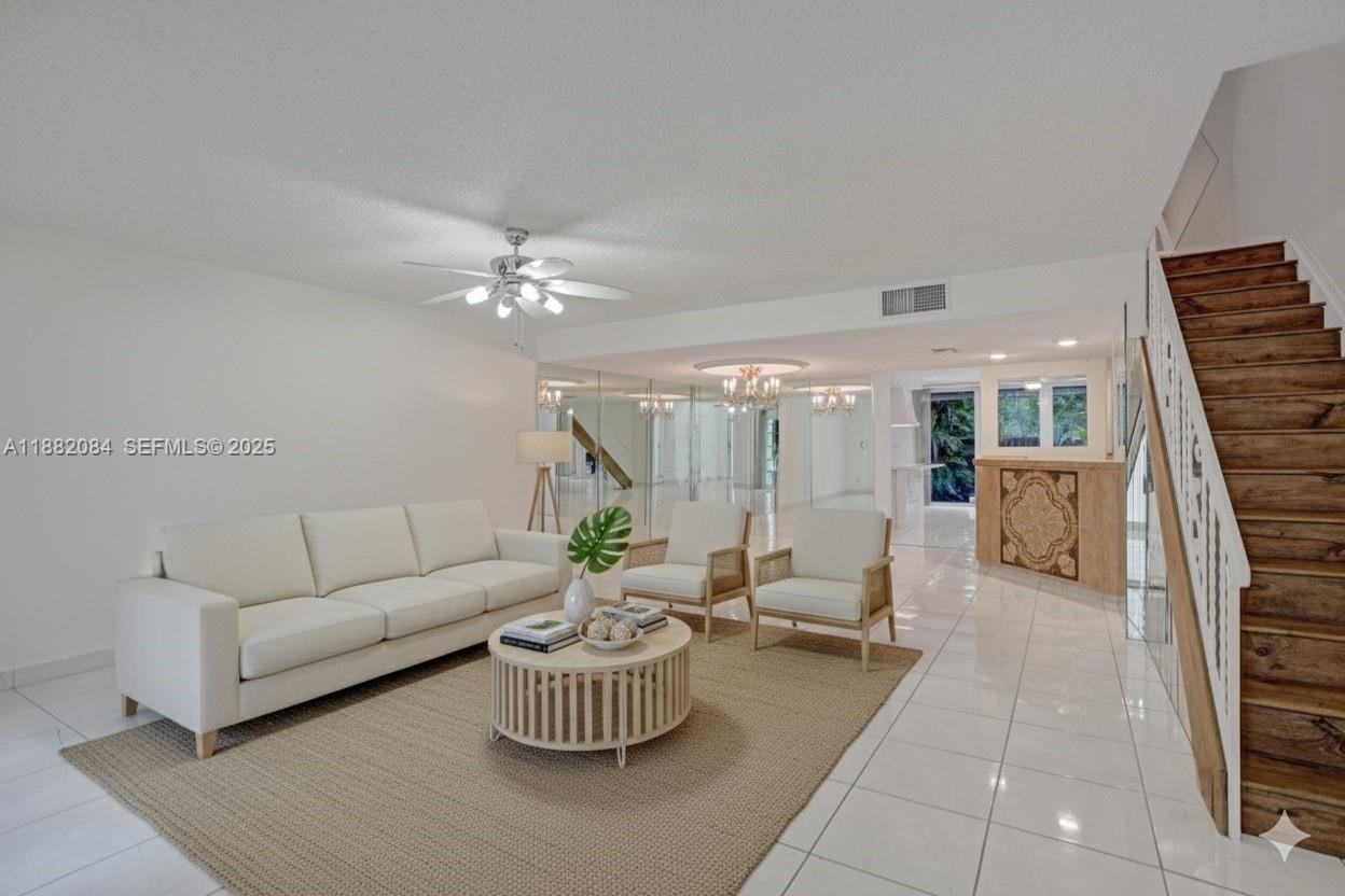 Best value and best location in the highly desirable Three Islands community—this beautiful 2-bedroom, 2.5-bath townhome offers an exceptional opportunity for both primary owners and investors, with the ability to rent immediately after purchase. Located in the sought-after Venetian Townhomes West community, it has been significantly upgraded, including a new 2024 roof, hurricane-impact windows and doors, new A/C, new refrigerator, new second-floor flooring, fresh interior paint, updated window treatments, and newly resurfaced front and back patios. A brand-new motorized outdoor awning enhances the private outdoor space. Ideally positioned within the community, the spacious fenced backyard opens directly to Three Islands Park, offering instant access to playgrounds, basketball courts, and scenic walking paths—an extension of your living space. Residents enjoy resort-style amenities including a heated pool, tennis courts, and clubhouse, while maintenance conveniently includes water, cable, and internet. The seller paid off the remaining assessment in full. Just minutes from the beach, shopping, dining, and major airports, this move-in-ready townhome delivers the perfect balance of lifestyle, location, and immediate income potential.