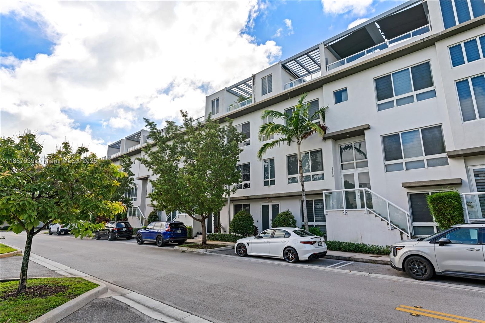 La Premiere Realty is proud to present this TURN-KEY, spectacular 4-level townhouse in Landmark at Doral—loaded with upgrades! Enjoy private elevator access to all four levels, a chef’s kitchen, and an expansive master suite with a seating area and walk-in closets. Each of the three bedrooms features its own full bath and walk-in closet, plus there are 2 additional half-baths for guests. The 2-car garage boasts custom flooring, overhang storage, and modern cabinetry. The open-concept kitchen and living space are ideal for entertaining, enhanced by built-in surround sound. The crown jewel: a 4th-level rooftop terrace with a half-bath, jacuzzi, retractable electric awning, built-in BBQ, and mini fridge. This home seamlessly blends style, function, and luxury—ready for you to move in.