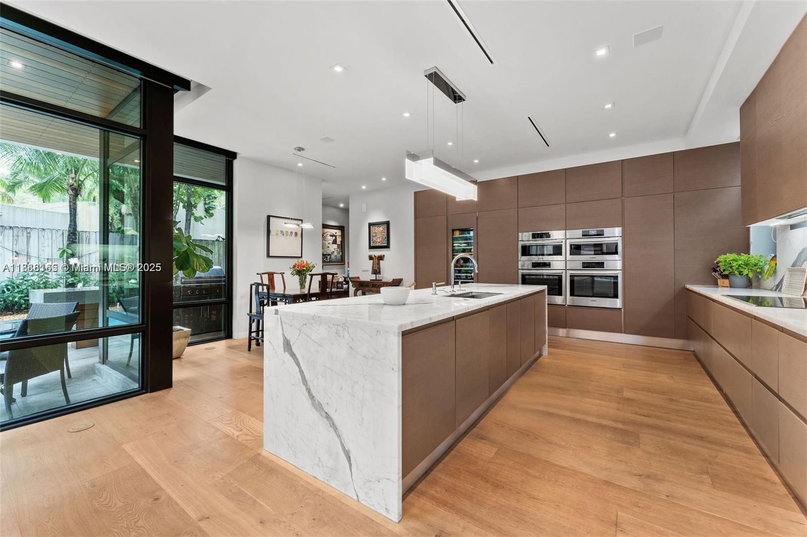 In the heart of a coveted North Coconut Grove street, is a finely crafted home on a 9000 sq ft lot. Built by and for a prominent South Florida Developer & his wife, no expense or detail was spared. This was not a “spec house” and it shows! Heated 40 ft lap pool, a sleek Italkraft kitchen, Bosch appliances, perfectly matched Calacatta marble, 4 ovens (including steam), wine cooler, French Oak floors throughout. The primary is a sanctuary with a spa-like bath. For late-night cravings, a “midnight bar” adds an extra touch of indulgence. Take the elevator to your rooftop terrace, ideal for alfresco dining. Walk/ bike to the Village & Biscayne Bay. Minutes to Brickell, the airport, major shopping, Key Biscayne beaches. Luxury, convenience, natural beauty.