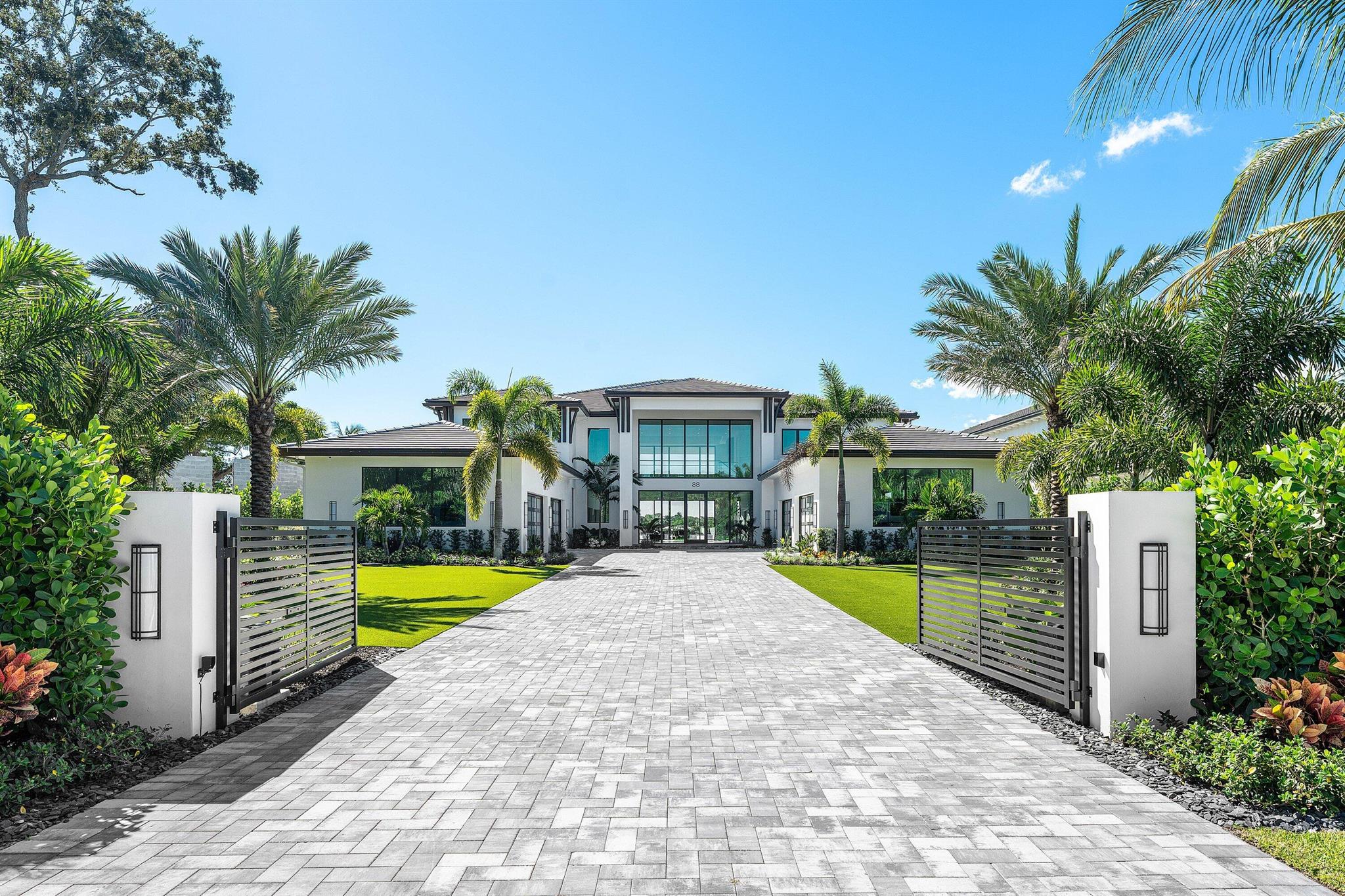 Experience unmatched luxury on the Loxahatchee River with this new waterfront estate offering panoramic blue water views. Featuring 23' ceilings, a striking floating staircase, and expansive living areas, the home is ideal for entertaining. The chef's kitchen boasts backlit quartz and seamless water vistas. The master retreat includes a fireplace sitting room, spa bath, dual closets, and balcony, with four en-suite guest suites. Outdoors, enjoy an infinity pool, spa, firepit, waterfall and new dock. An 8-car garage with clubroom, den, and gym add versatility. Recent upgrades include turf, putting green, enhanced privacy landscaping, premium landscape lighting, and new hurricane shades on the covered patios. A true boater's paradise.