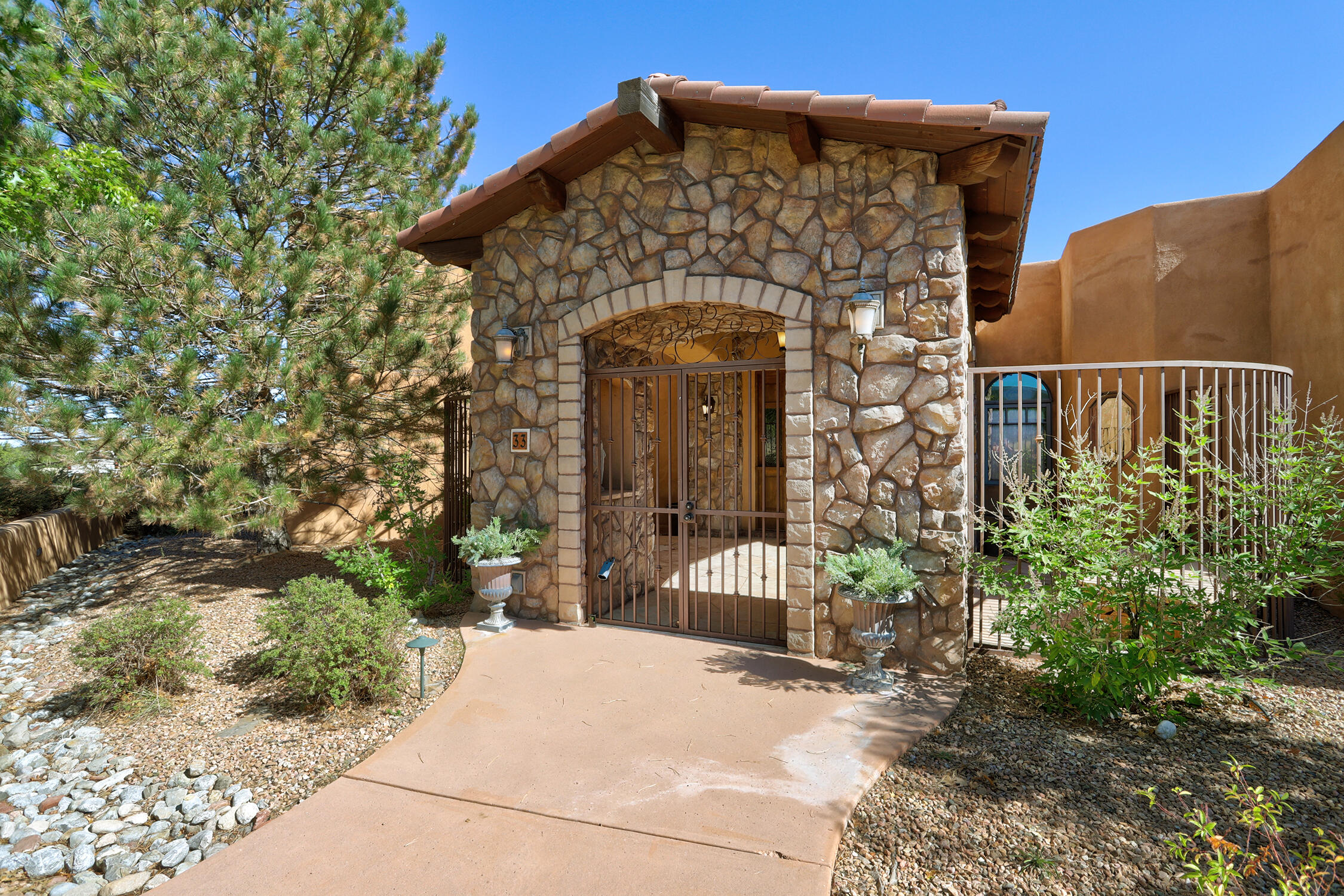 WOW to this new price for this estate on over 10 acres!  Luxury plus warmth & charm, this gem feels like you're in the heart of Tuscany. Tiled floors, barrel ceilings, stone accents, wood beams & custom cabinetry set the tone. The chef's kitchen boasts Wolf, Sub-Zero & Asko appliances, granite counters, pot filler, prep island & walk-in pantry. A butler's pantry w/stained glass opens to formal dining room w & a two-way fireplace into living room. Entertain in the theater w/wet bar, or gather in the grand living room. A home office offers it's own gas fireplace, drafting room & separate entrance. Also find a charming FURNISHED guest house w/full kitchen & upstairs suite. A  4-car garage completes this dream estate + in 2024 a new TPO roof was installed.  Make this your dream home today!