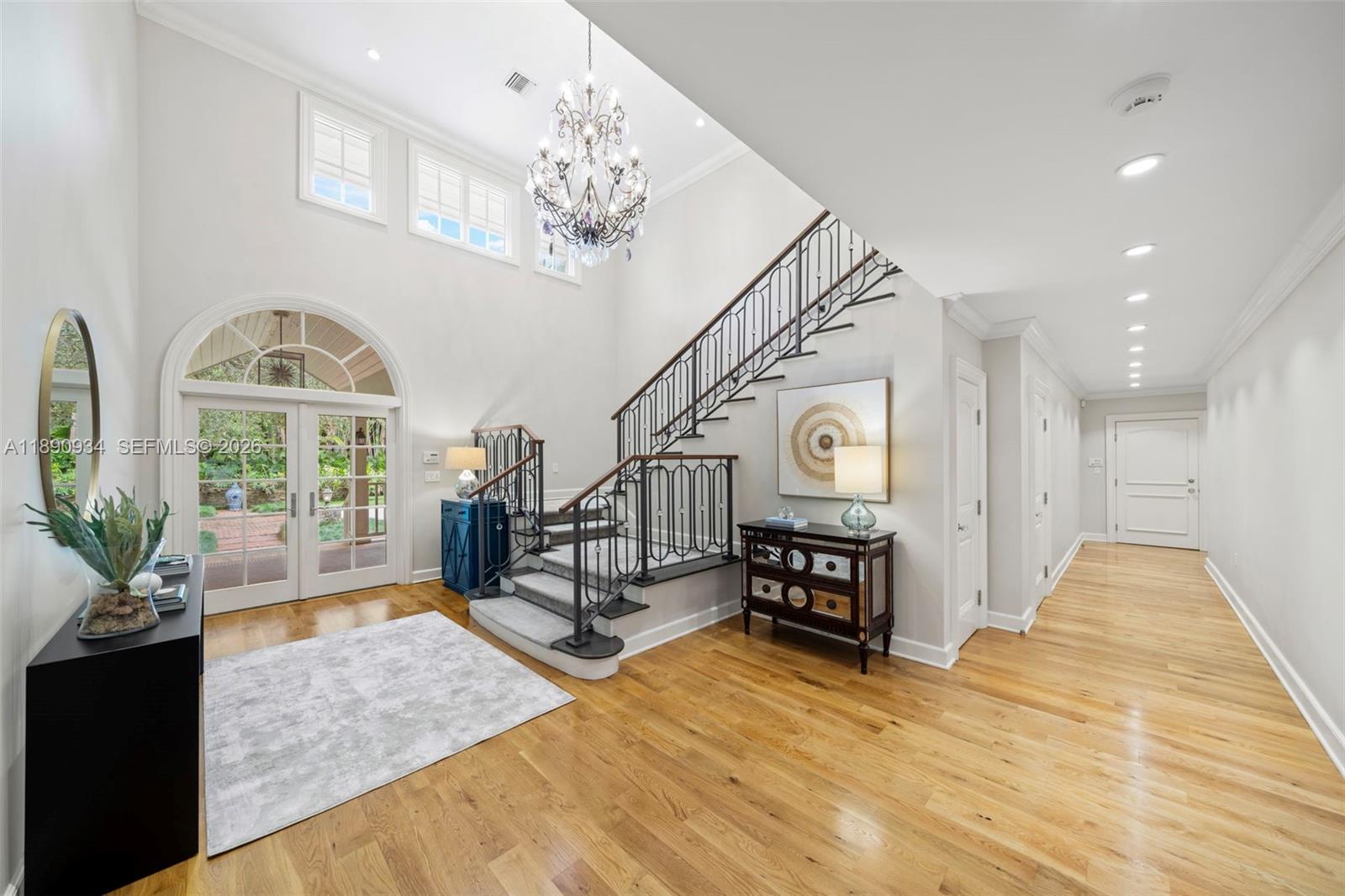 SIGNIFICANT PRICE ADJUSTMENT. Tucked within the exclusive gated community of Banyan Lakes, this custom estate exudes timeless Coral Gables elegance. Set on a breathtaking 50,000+ SF lot, the property is surrounded by majestic live oaks, manicured terraces, and a resort-style lagoon pool—creating a private, park-like retreat. Spanning 8,765 SF, this 6-bedroom, 5.2-bath residence is designed for gracious living and entertaining. The home features a formal living room opening to a serene Zen garden, family room w/ fireplace & custom built-ins, & chef’s kitchen with Wolfe & SubZero appliances, banquette seating, & butler’s pantry. The primary BR includes gym, 2 walk-in closets, & spa-like bath. Additional highlights include white oak floors, impact glass, metal roof, generator, & 2-car garage.