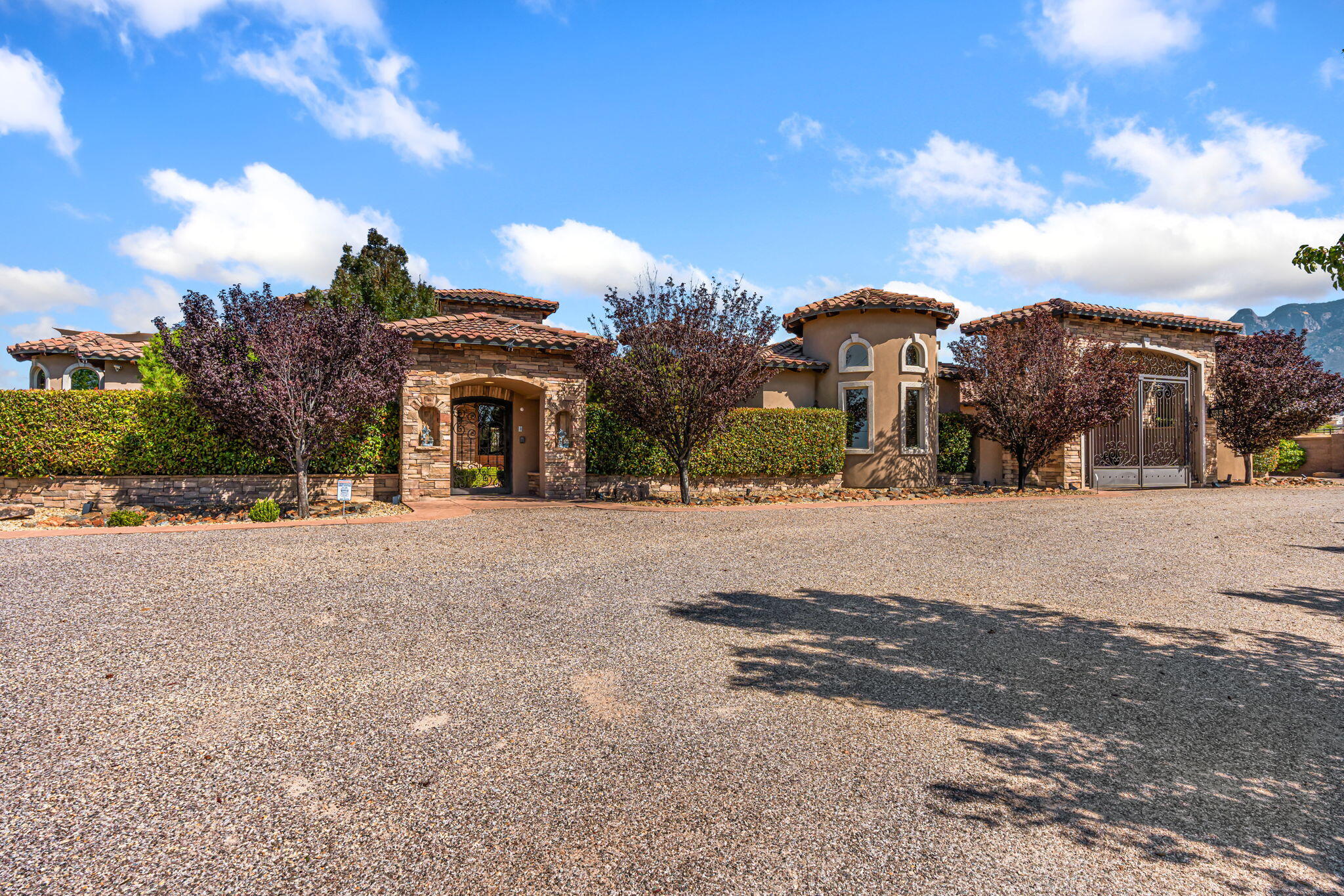Designed to impress, this elegant estate by Renaissance Custom Homes is a private sanctuary made for luxurious living and effortless entertaining. Step inside and feel the rich architectural details. Stunning living area with chiseled travertine floors, wood beamed ceiling, gas fireplace with stacked stone surround & built-ins that add both warmth & character. Impressive kitchen showcasing handcrafted cabinetry, rich granite, commercial-grade appliances, culinary island lit by a skylit architectural alcove. Media room is an entertainers dream with an onyx bar, fireplace and a wall of retractable doors combining the outside space. Resort style courtyard sits at the core of the home with a sparkling pool, pizza oven, outdoor kitchen, rooftop deck and basketball court!