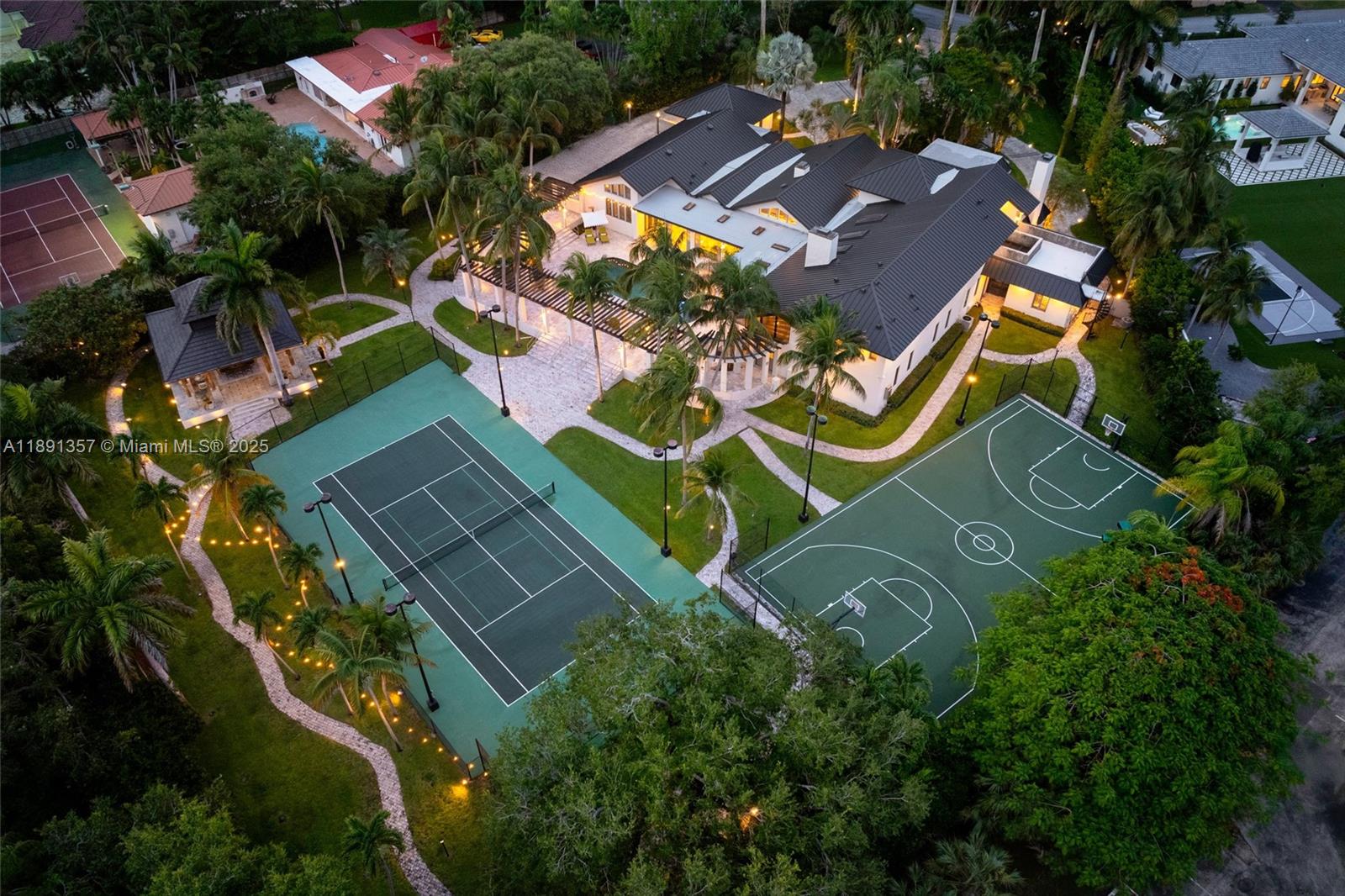 Magnificent palm trees frame this rare estate, an impressive and breathtaking 2.16-acre, 7-bedroom gated oasis in Miami. Nestled along the prestigious Old Cutler Road corridor in North Palmetto Bay, this signature property offers 10,274 SF of unrivaled privacy and resort-style grandeur. A lighted tennis/pickleball court and a separate lighted basketball court elevate the outdoor experience. Designed for both relaxed family living and refined entertainment, this custom residence with a 2025 metal roof includes a guest wing ideal for multigenerational lifestyles. Thoughtfully designed with a home office, billiard room, and a gym for modern living.  Top rated schools, golf, tennis, bike trails, and boating are nearby for a quintessential South Florida lifestyle.