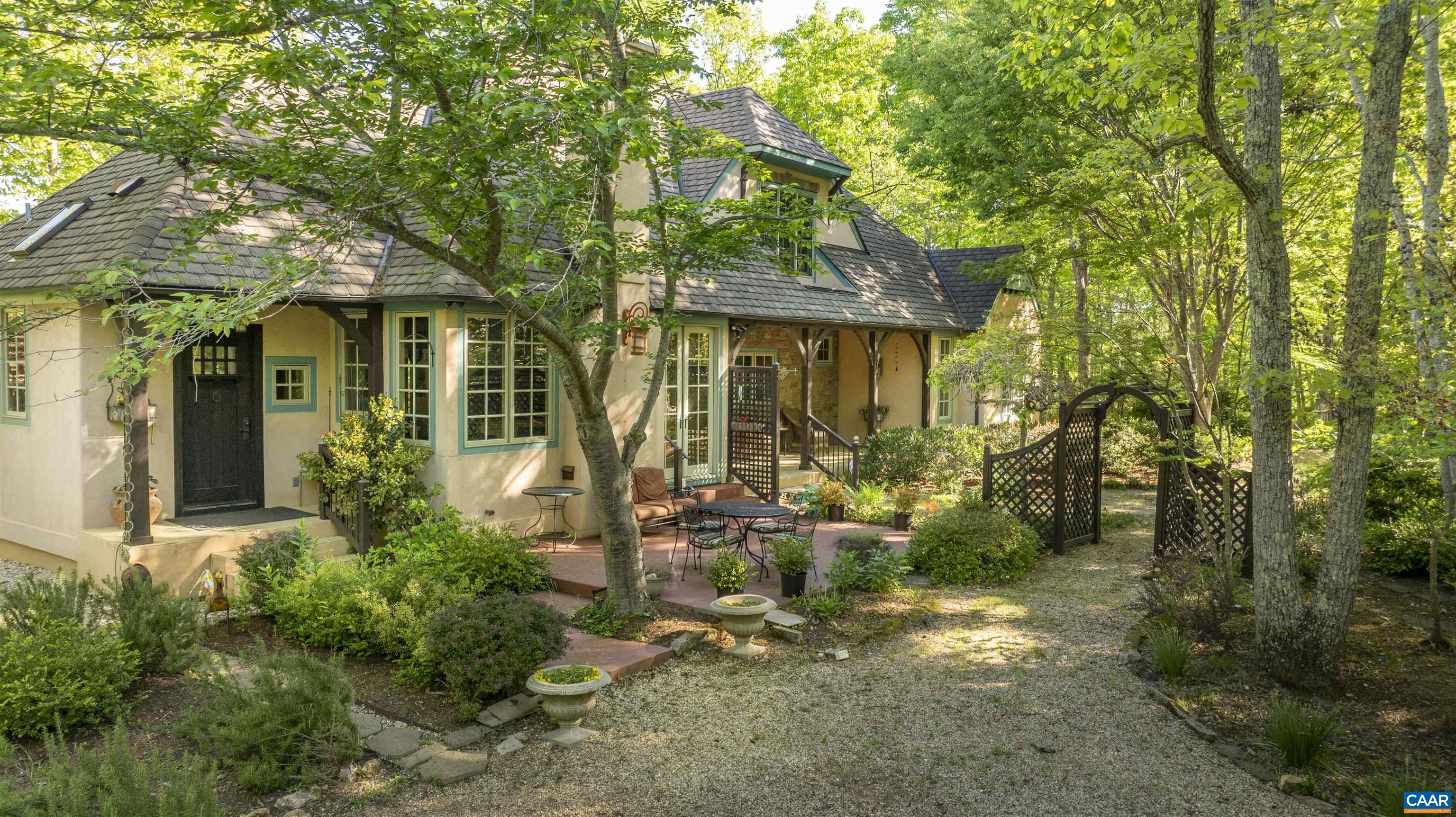 Set on 34.5 acres in Albemarle County, this custom Timberpeg hybrid home is a private retreat built for both work and play. Vaulted timber-frame ceilings, arched windows, and a travertine fireplace bring European-inspired style, while the chef’s kitchen—with arched cooking hearth, travertine sink, and island—anchors the main living space. Flexible interiors include a loft, studio above the garage, and a spacious lower level with full walkout, perfect for a gym, gaming setup, or creative workspace. Outside, trails wind through woods and past a spring-fed pond, while stone patios and landscaped gardens provide places to unplug. A separate log cabin guest house welcomes friends or serves as a private crash pad. The barn offers paddocks and pasture for horses, but with high-speed fiber internet, it also doubles as a large office, workshop, or start-up hub. Remote yet connected, this property blends total privacy with modern infrastructure—ideal for anyone seeking a self-sufficient base close to the James and Rockfish Rivers, with added value through division rights and forestry-use tax advantages.