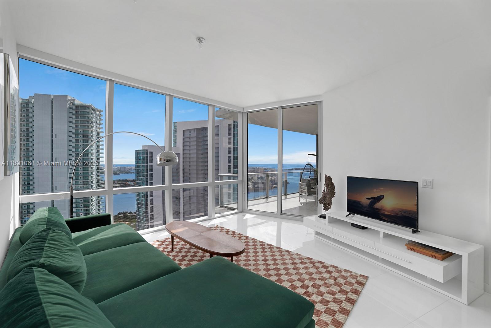 SELLER OFFERING ONE FULL YEAR OF HOA DUES PAID — A RARE OPPORTUNITY TO OWN WITH NO HOA COSTS FOR THE FIRST YEAR. NOW PRICED TO SELL. Welcome to Residence 4403 at Paramount Miami Worldcenter, home to Miami’s largest amenity collection. Resort style living on the desirable 44th floor with direct bay views and sunlit interiors framed by floor to ceiling glass. An open floor plan places the kitchen and waterfall edge island facing the living area for effortless entertaining, with a split bedroom layout and a versatile den. Finishes include top of the line appliances, custom built out closets in both bedrooms, and a primary bath with dual vanity sinks, bathtub, and separate shower. A private elevator opens to your own foyer. Additional features include 10 ft ceilings, a bay facing balcony, laundry room, and storage throughout. Premier parking with assigned spaces next to the elevator plus one valet space.