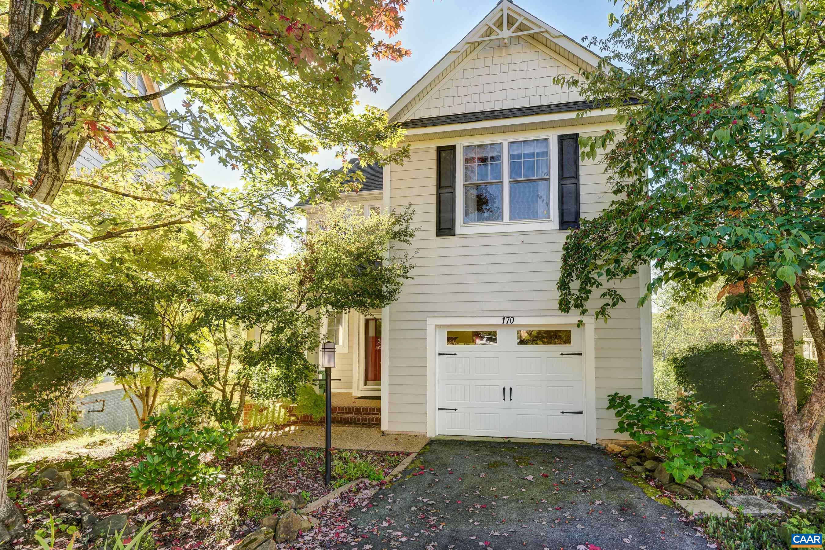 You'll love the seasonal mountain views that can be seen from either of two composite decks. This charming home backs up to the Rivanna Trails and Moores Creek, and feels like a tranquil oasis, yet is walkable to Downtown Charlottesville, and is minutes from I64.  With no HOA, this home could be a great Air BnB unit! The open floor plan of the main level includes three light-filled living spaces with a great room and dining area that flow into the practical and polished kitchen. Hardwood floors sparkle in the light from the wall of windows overlooking the natural spaces behind the home.  Upstairs, the primary suite includes an ensuite bathroom with heated tile flooring, soaking tub, and separate shower.  Two additional bedrooms share a full hall bathroom, and the laundry room is upstairs for convenience. A loft space upstairs makes a great space for a home office or reading nook.  Enjoy even more living space with a large walk-out lower level featuring a rec room leading to a second deck with pergola and full bathroom. With solar panels to keep the energy costs low, a one car garage, and so much more, this home is a must see!