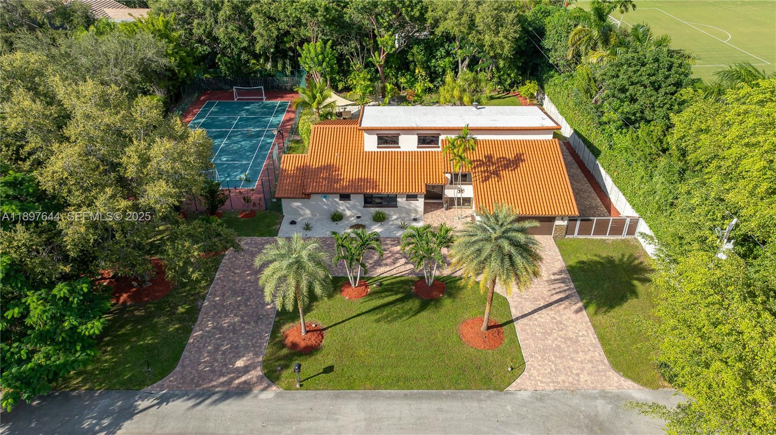 Escape to your private paradise in this stunning Palmetto Bay estate with no HOA! Set on a 21,867 SF cul-de-sac lot, this 4,665 total SF home offers true resort-style living with a sparkling pool, summer kitchen, covered patio, and your own multi-sport court for tennis, soccer, basketball, and more. Enjoy lush landscaping, and an expansive driveway. Inside, soaring ceilings and oversized windows fill the home with natural light. Plus, there’s ample space for an RV and boat. Your South Florida dream retreat awaits!