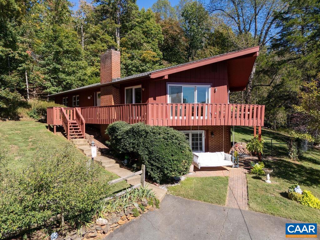 Don't miss this Mid-Century gem in Ivy's Glenaire neighborhood, located in the Ivy Elementary District & @15 minutes to UVA, shopping & restaurants. Perched to capture elevated views, this beautifully updated home features open-concept living w/ wood-burning fireplace & walls of sliding glass doors that open to an impressive three-sided wraparound deck—ideal for relaxing, entertaining or just enjoying the panoramic views. Light-filled kitchen includes white cabinetry, quartz counters & custom built-in breakfast bar. The main level offers easy one-level living and includes a beautiful primary suite w/ renovated bath, two additional bedrooms & full bath. The walk-out lower level adds flexible space w/ a cozy family room, additional bedroom, full bath, laundry, workshop & abundant storage in the pristine crawl space. Notable improvements include: private well upgrade (2025), new light fixtures (2025), EV charging capability (2024), Painted exterior (2024), HVAC (2022), most plumbing replaced (2021), Generac generator (2021), new sliding doors & double-pane windows (2019).