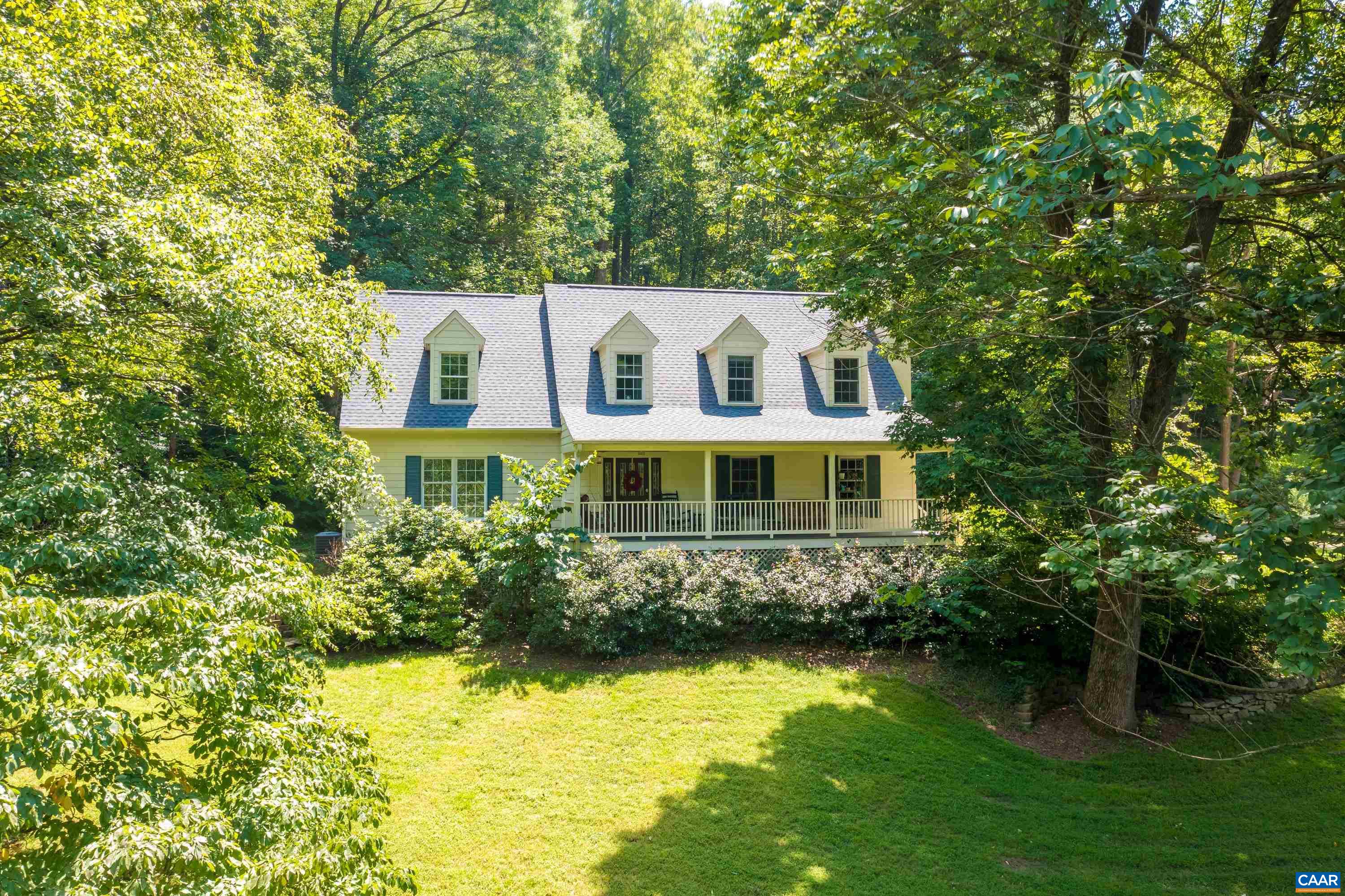 This stunning 26 acre estate offers a blend of natural beauty & modern comfort. Taylor Creek meanders through the property, creating a serene backdrop of babbling waters. This home is a true retreat with endless possibilities for outdoor recreation or peaceful relaxation.The beautifully updated home boasts a newly renovated kitchen featuring gleaming new countertops, state-of-the-art appliances, & refinished antique pine floors that add timeless charm. The newly completed basement expands the living space with a cozy family room, an additional bedroom, & a full bath, ideal for guests or extended family. The primary suite offers a gas fireplace & a fully renovated bathroom showcasing new flooring, a heated towel bar, &  a tiled shower with glass door. The living room w/wood-burning fireplace, exudes warmth, while the adjacent dining room is perfect for gatherings. Upstairs, 2 additional bedrooms and full bath provide ample space for family or visitors. Enjoy mornings on the covered front porch or unwind on the screened porch, overlooking a lovely fish pond. The detached garage/workshop is a standout feature, with a finished space above that could serve as an apartment, office, or creative studio. High Speed Internet!! NO HOA!