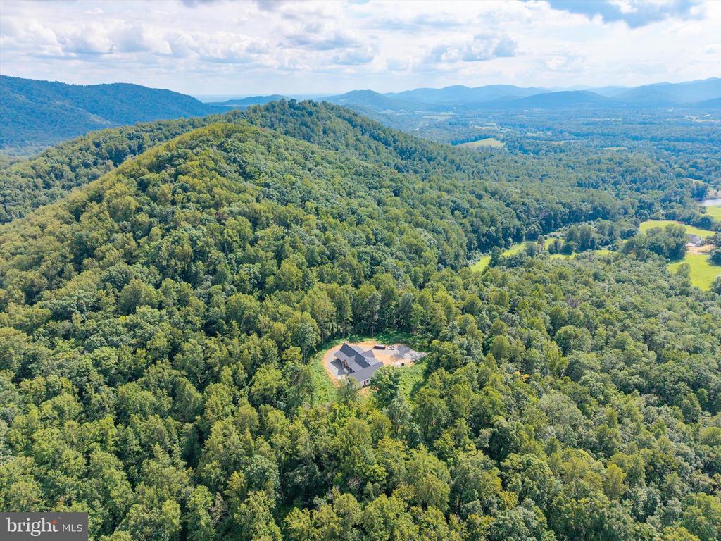 COMPLETION SET FOR DECEMBER 2025! ONCE IN A LIFETIME LUXURY NEW CONSTRUCTION IN THE PRESTIGIOUS BLANDEMAR ESTATES SUBDIVISION! This luxury gem is nestled on 24 private acres with panoramic views of mature hardwoods and the breathtaking Blue Ridge Mountains. This exceptional 4,806 SF estate with a FLAT HOMESITE offers refined one-level living with 5 spacious bedrooms and 4 beautifully appointed bathrooms. A small, serene creek meanders through the edge of the property, enhancing the peaceful, secluded setting. Inside, the custom design and finishes are second to none ”” from the gourmet kitchen with panelized appliances, floor-to-ceiling cabinetry, and a large walk-in pantry, to the vaulted and tray ceilings, custom-stained plank ceilings, and expansive open-concept living spaces (more....) Entertain in style with a dedicated wine area featuring 300-bottle built-in wine storage coolers, a wet bar with sink and kegerator, and a cozy lounge with fireplace. The luxurious master suite wing and separate full guest suite offer privacy and comfort, while a fitness room, sauna/hot tub connection, and outdoor shower elevate the lifestyle. Step outside to expansive covered porches with fireplaces perfect for year-round enjoyment of the mount