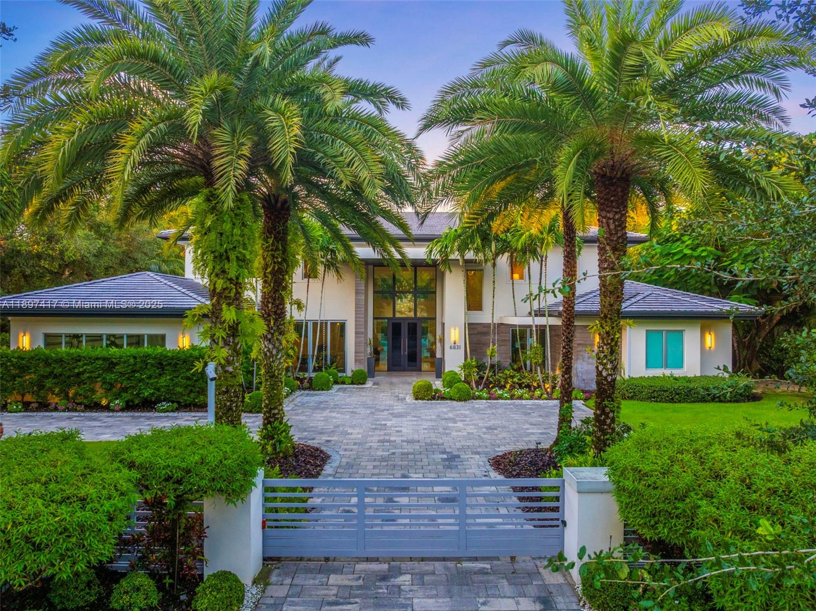 Just a 5-minute drive to Gulliver Prep and close to Miami’s top schools, this gated 6-bed, 7-full and 2-half-bath modern estate blends sophistication with effortless livability. The home features soaring ceilings, dramatic windows, and impeccable design. Elegant living and dining areas flow into a chef’s kitchen with premium appliances, custom cabinetry, and a spacious island for gatherings. Five en-suite bedrooms include a primary suite with dual walk-in closets, spa-like bath, and private balcony. A home theater, wine cellar, office, and integrated smart-home technology elevate everyday comfort. Outdoors, a tropical oasis with multiple covered terraces designed for year-round entertaining. A beautifully finished 1-bedroom, 1-bath guest house provides a private retreat for visitors.