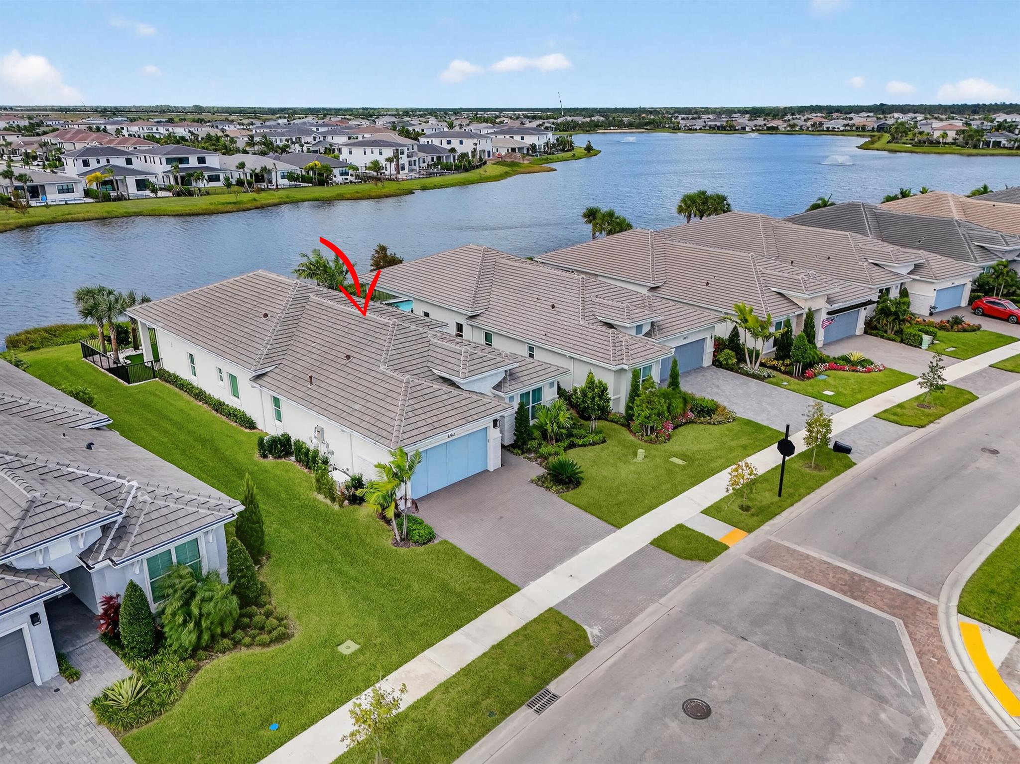 This beautifully appointed 3-bedroom plus office, 3-bath home offers an open and airy floor plan with a bright coastal feel and stunning wide water lake views. Western exposure provides magnificent sunsets that can be enjoyed from the extended lanai patio, creating the perfect setting for entertaining or relaxing by the water. The home features a Tropical-inspired backyard complete with astro turf, a golf putting area, and remote-controlled hurricane patio screens for year-round comfort. Inside, every detail has been thoughtfully upgraded, whole house, Generac Generator, oversized 8-blade ceiling fans with lights in the living areas, bedrooms, and patio, custom blinds on all windows, upgraded light fixtures, and an oversized jetted tub in the primary suite and comfort height toilets.