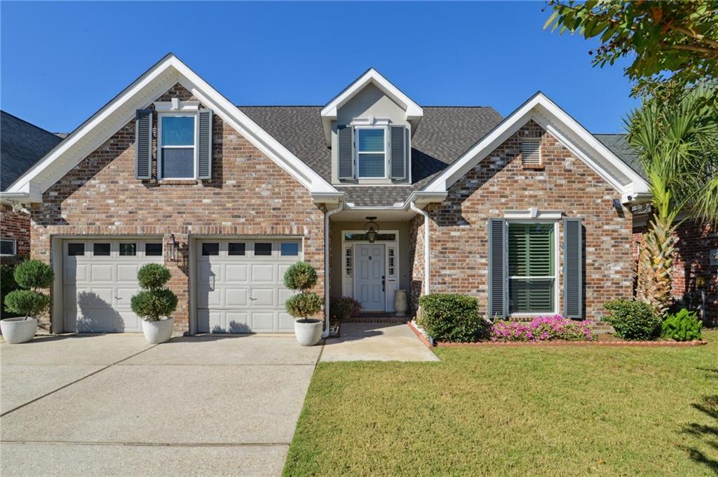 Welcome home to this beautifully updated and meticulously maintained residence on a quiet, family-friendly street surrounded by newer homes. Thoughtfully designed for comfort, convenience, and peace of mind, this home offers both modern style and exceptional functionality.

Inside, you’ll find 4 spacious bedrooms plus a dedicated office or flex room, providing plenty of space for work, play, and everyday living. The bright living room features a striking two-story cathedral ceiling, cozy fireplace, and built-in bar—perfect for gatherings with family and friends. The primary suite is conveniently located on the main floor and features a beautifully updated bath for privacy and ease.

The chef’s kitchen is a true highlight, featuring granite counters, a gas stove and. high-end appliances. It flows seamlessly into a separate breakfast room for casual dining and a formal dining room for hosting special occasions.

Enjoy peaceful moments in the sunroom, an ideal spot for morning coffee or birdwatching, or step outside to the outdoor patio with an adjustable louvered roof system, designed for rain, shade or shine and year-round enjoyment.

Built for long-term comfort and security, this home features updated windows, hurricane shutters, a whole-home generator, and a Post-Ida roof with transferable warranty. The detached workshop/shed with AC and an overhead door is perfect for hobbies or extra storage. Additional highlights include beautiful plantation shutters throughout the home, a two-car garage with AC/heat, and X-zone flood for added peace of mind.

With its thoughtful updates, flexible layout, storage galore and inviting spaces inside and out, this move-in-ready home is perfectly suited for family living. Don’t miss your chance to call it home!