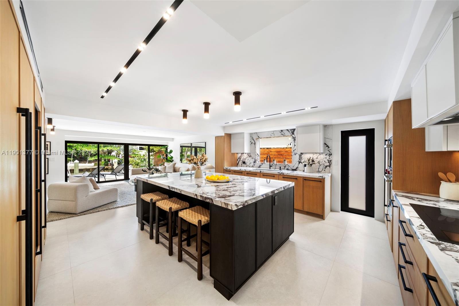 A Modern Boater’s Paradise — This exceptional waterfront residence in Coconut Grove seamlessly blends architectural elegance with contemporary comfort. Completely reimagined, the 4BR/4BA home features Italian porcelain flooring, white oak finishes, bespoke millwork, and Lutron lighting throughout. The chef’s kitchen is a showpiece with Sub-Zero and Wolf appliances, a built-in coffee system, Grand Viola marble countertops, and custom cabinetry. Thoughtful upgrades include a new roof, new impact windows and doors, and new electrical, ACs and plumbing. Outdoors, lush tropical landscaping, a sparkling new pool, summer kitchen, and integrated sound system frame 50 feet of private dockage offering direct, unobstructed bay access. Excellent location close to Brickell and Center Grove.