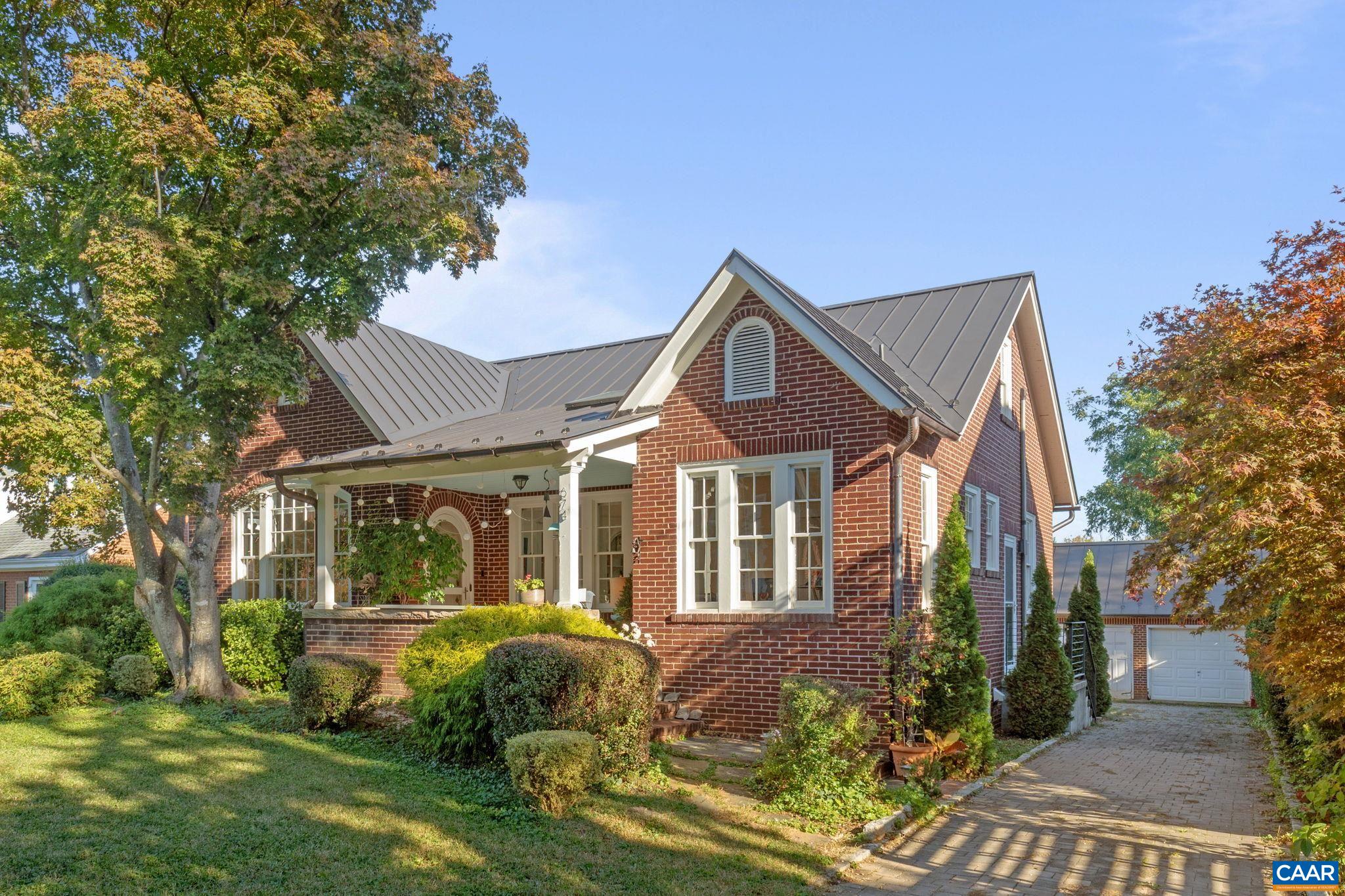 Open your next chapter in this storybook c. 1930 cottage perfectly situated on dogwood-lined Evergreen Ave-one of North Downtown’s most beloved streets, along the 10-Miler route. A rare offering that blends timeless character w/ exquisite updates, this home delights at every turn. The inviting covered front porch and arched entry lead to a JEWEL BOX INTERIOR bathed in light streaming through architectural windows, 9.5' ceilings, handsome built-ins and white oak + southern yellow pine floors. The Karen Turner-designed kitchen is a SHOWSTOPPER, featuring Carrara marble counters, black walnut island, custom cabinetry, Bosch/Wolf appliances, built-in pantry + appliance storage + coffee bar. Sunny breakfast nook overlooks a peaceful backyard with IPE decking + built-in planters. MAIN LEVEL LIVING possible with 1st floor bedrooms and full bath. Upstairs offers a 3rd bedroom, 1/2 bath + flex space. Mountain views to the SE! Recent upgrades-NEW HVAC (2023), NEW metal roof (2021) and 2 EV chargers. Potential for fabulous carriage house/studio in detached 2 car GARAGE w/ electric panel + water/sewer access. An ENTERTAINER'S DREAM w/ potential to reimagine / expand! Stroll downtown to boutique shopping and fine dining.