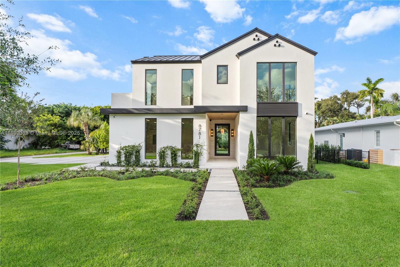 Spectacular new construction in the heart of South Miami! This Modern-Farmhouse offers the perfect blend of contemporary design and refined luxury, ideally located just minutes from downtown SOMI, Coral Gables, Pinecrest, and major highways. Featuring 5 spacious bedrooms (four upstairs) and 6.5 baths, the home boasts a sleek open layout with seamless indoor-outdoor living. Exquisite marble and porcelain finishes complement a MiaCucina kitchen, oversized butler’s pantry with wine storage, summer kitchen, cabana bath, and sliding glass doors opening to a private, lush backyard. The primary suite includes a private terrace, spa-inspired bath, and oversized walk-in closet. Set on a beautifully landscaped lot near top private schools, this home defines sophisticated South Miami living.