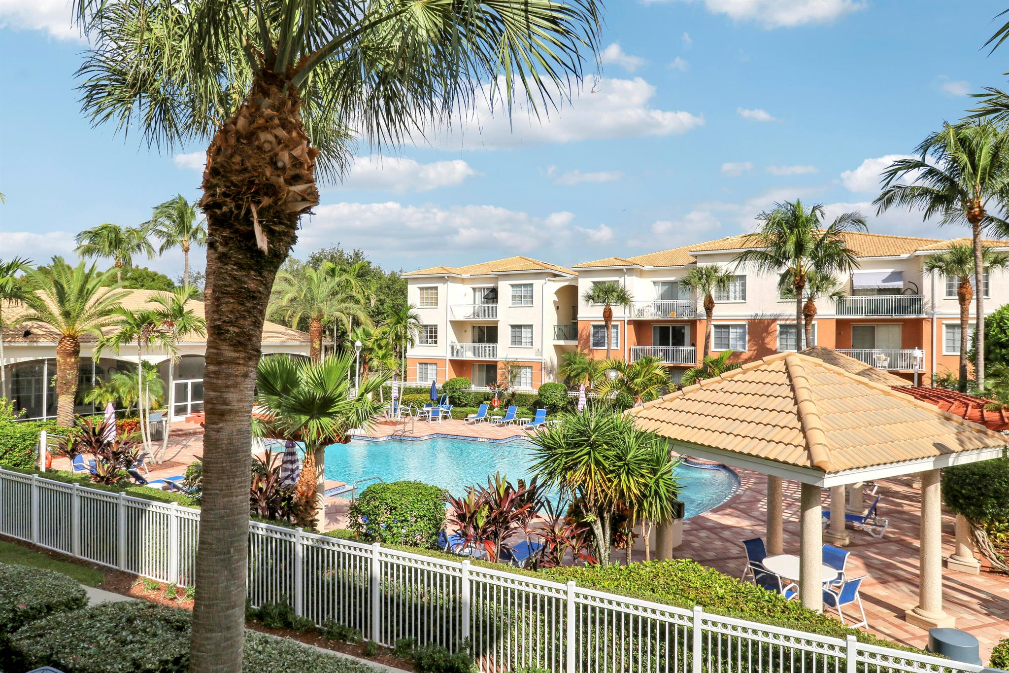 Experience upgraded living in this bright and airy 2nd-floor unit overlooking the pool, complete with an attached garage. Enjoy modern comforts including a new A/C, new appliances, quartz countertops with waterfall edge, crown molding, full-size front-load washer and dryer, and a private balcony with slate stone finishes. Nestled in a private gated community. This property offers peace of mind as the roof's were replaced in 2017, no special assessments, freshly repainted buildings, and exceptionally well manicured grounds. Amenities abound, including a gym, pool, cabana, BBQ grills, clubhouse, putting green, volleyball court, and car wash. Just minutes from the area's best beaches, dining, and shopping, this is your chance to experience all that Fiore at the Gardens has to offer.